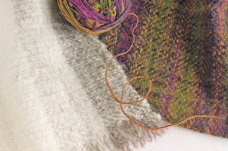 white and green/purple woven cloth