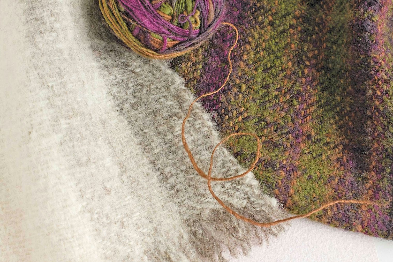 white and green/purple woven cloth
