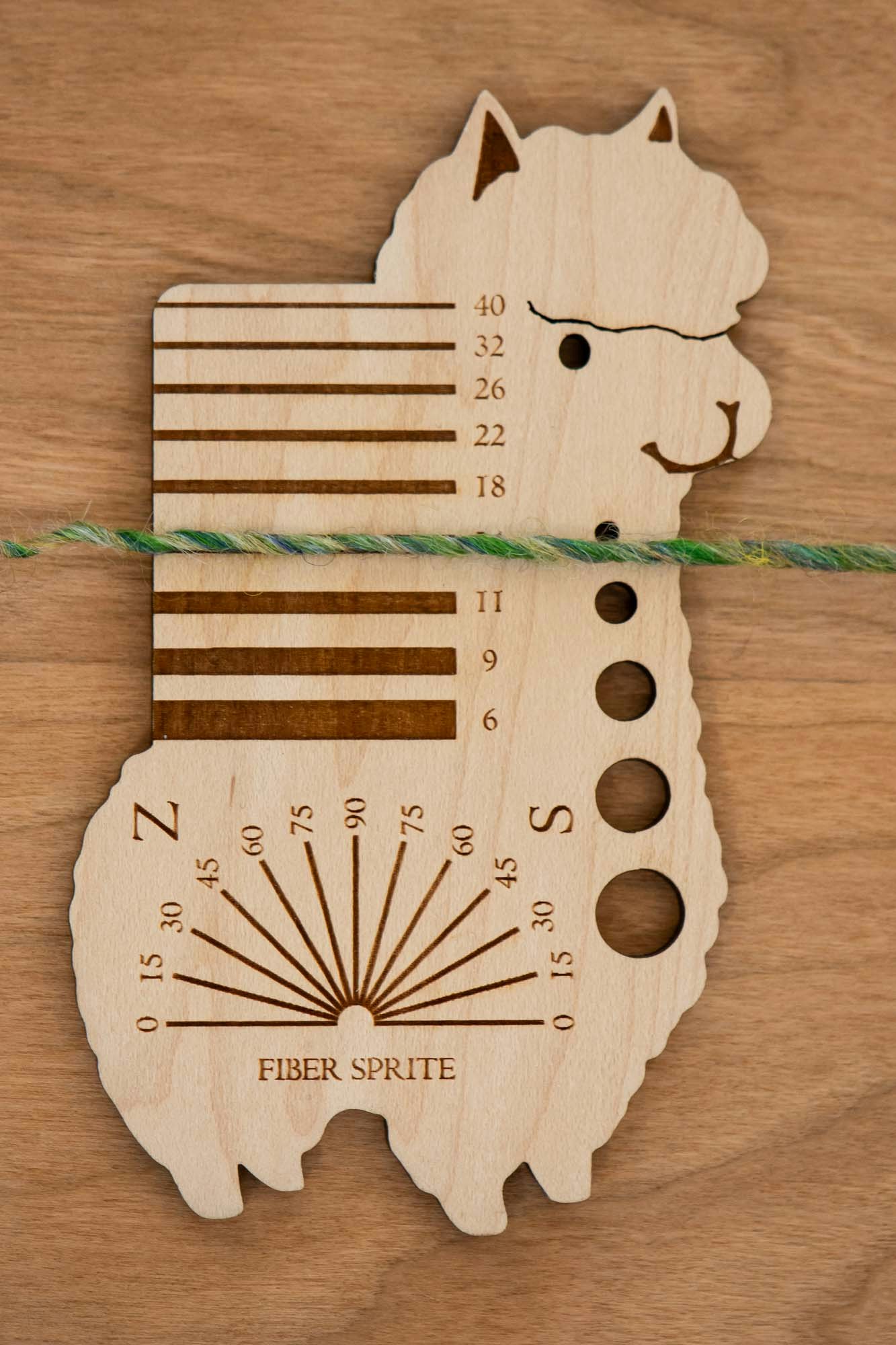 Lay the yarn across the grooves until you find the right measurement.