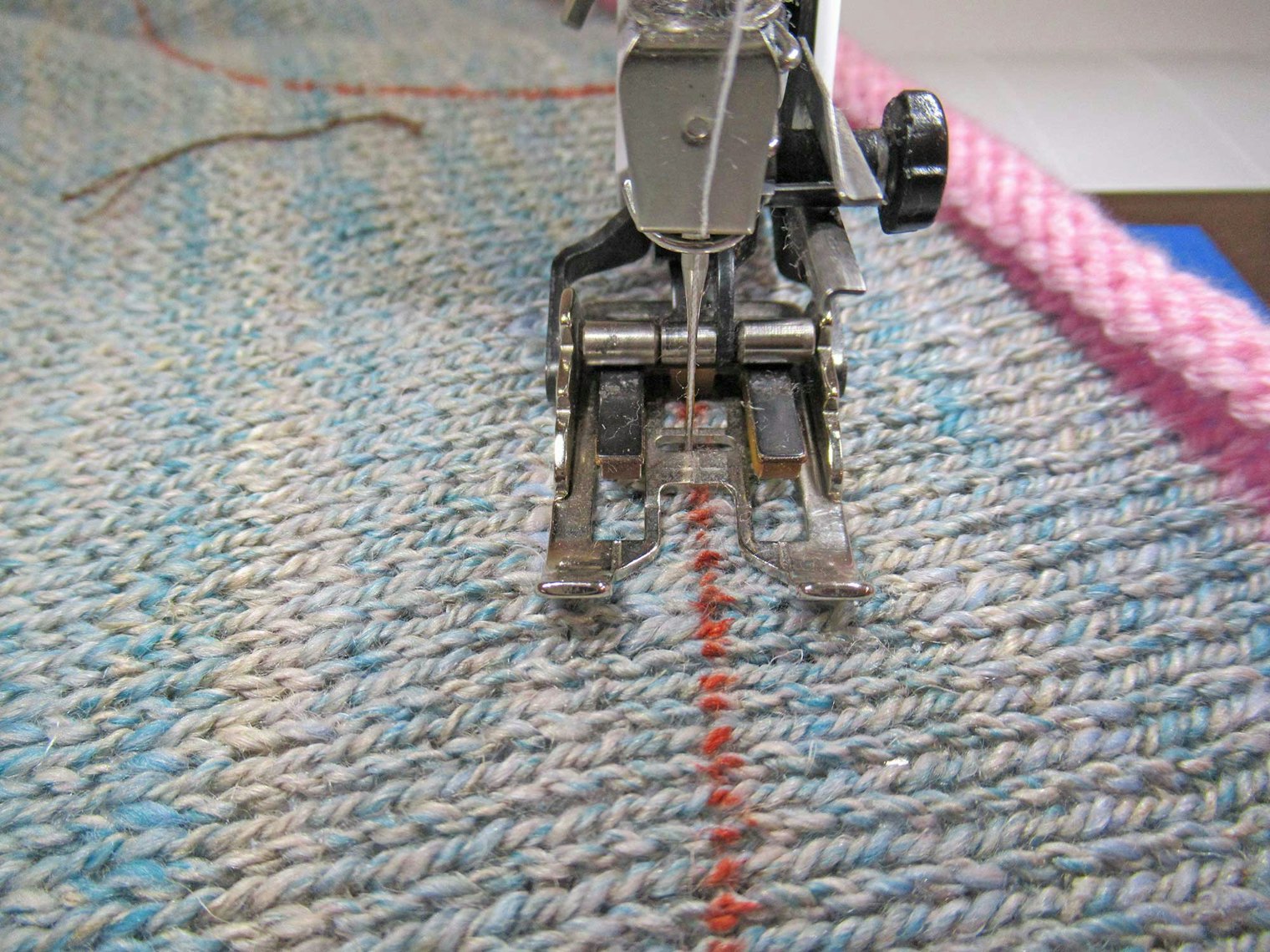 Using a straight stitch of 2.5 and stretch thread in the bobbin, Micki lined up the foot to the pattern line and moved the needle to the inside of it. After doing this twice around, the fabric is ready for cutting.