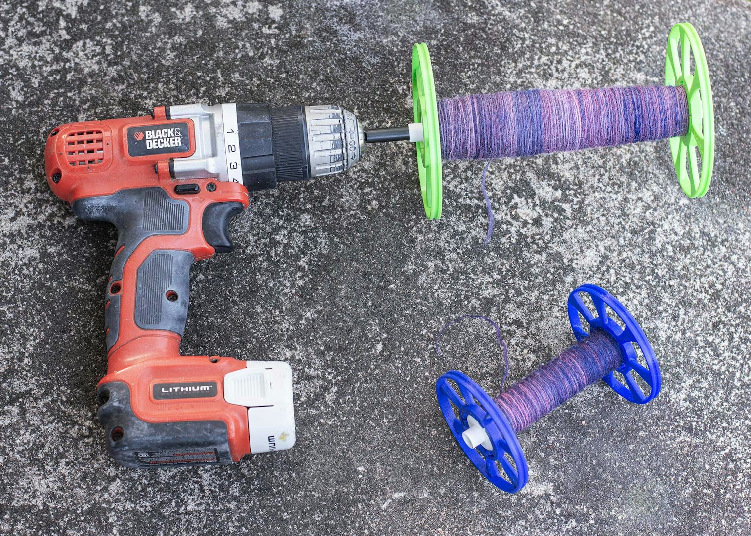 An electric drill used in conjunction with the Magic Winding Wand from the WooLee Winder Co, plus Schacht weaving bobbins fitted with Snap Storage Bobbins from the WooLee Winder Co.