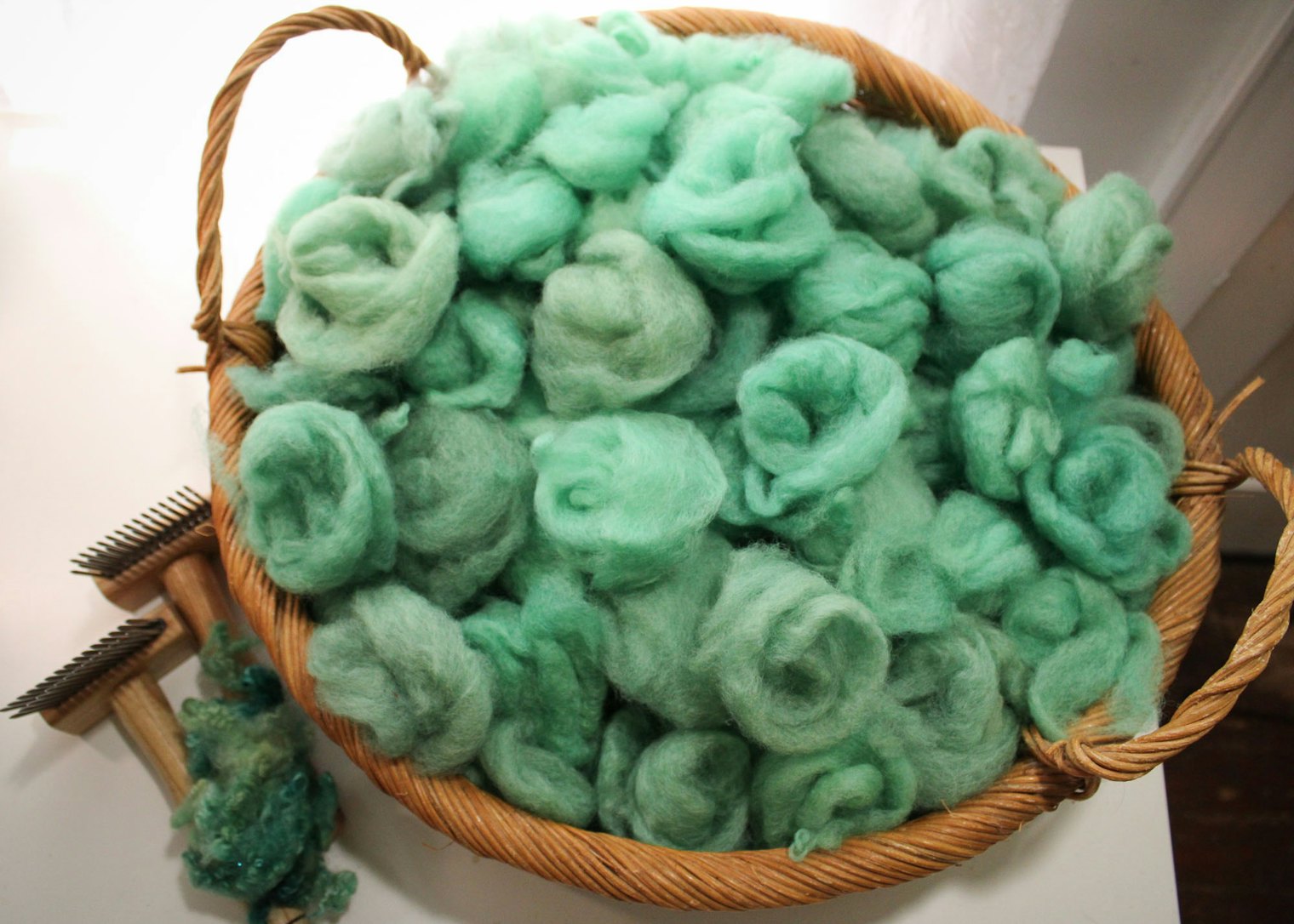 Debbie dyed this Finn fleece in shades of soothing green-grey, then combed and dizzed the locks for a worsted preparation.