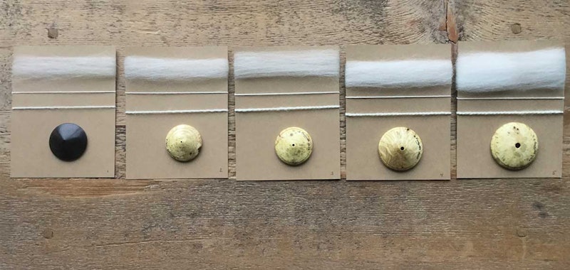 Five dizzes against a wooden surface. Each diz is shown with the sliver pulled from it and the resulting yarn spun from the sliver.