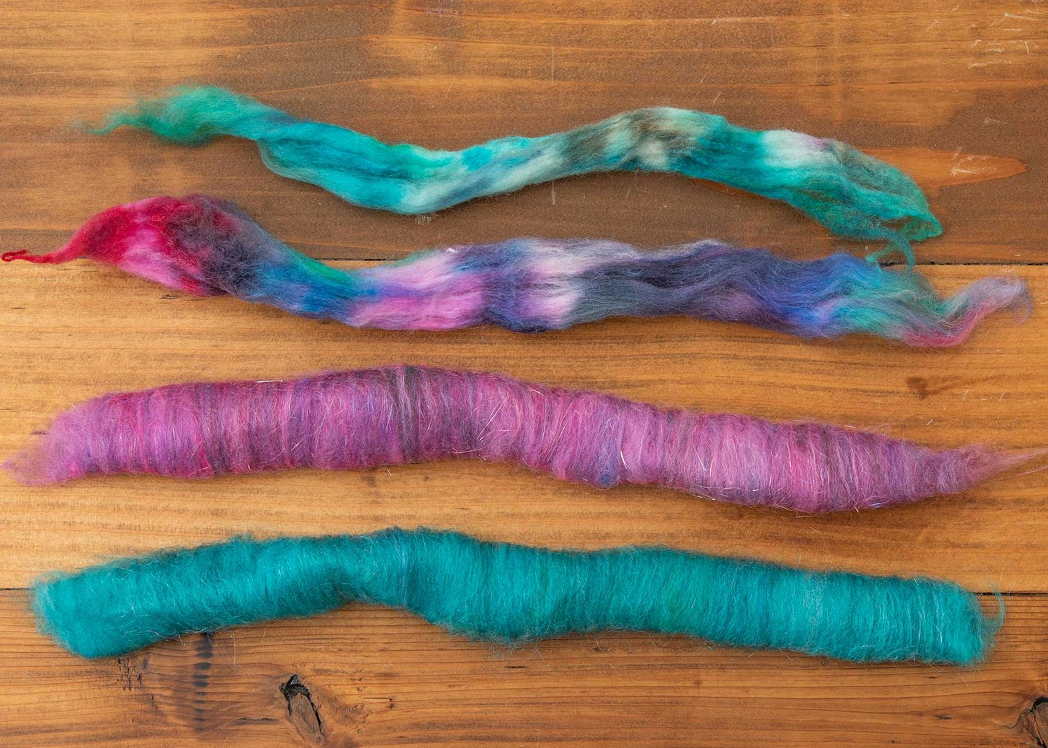 Blending dyed top into a rolag creates an instant heathered effect. A touch of sparkle in the purple rolag adds subtle visual interest.