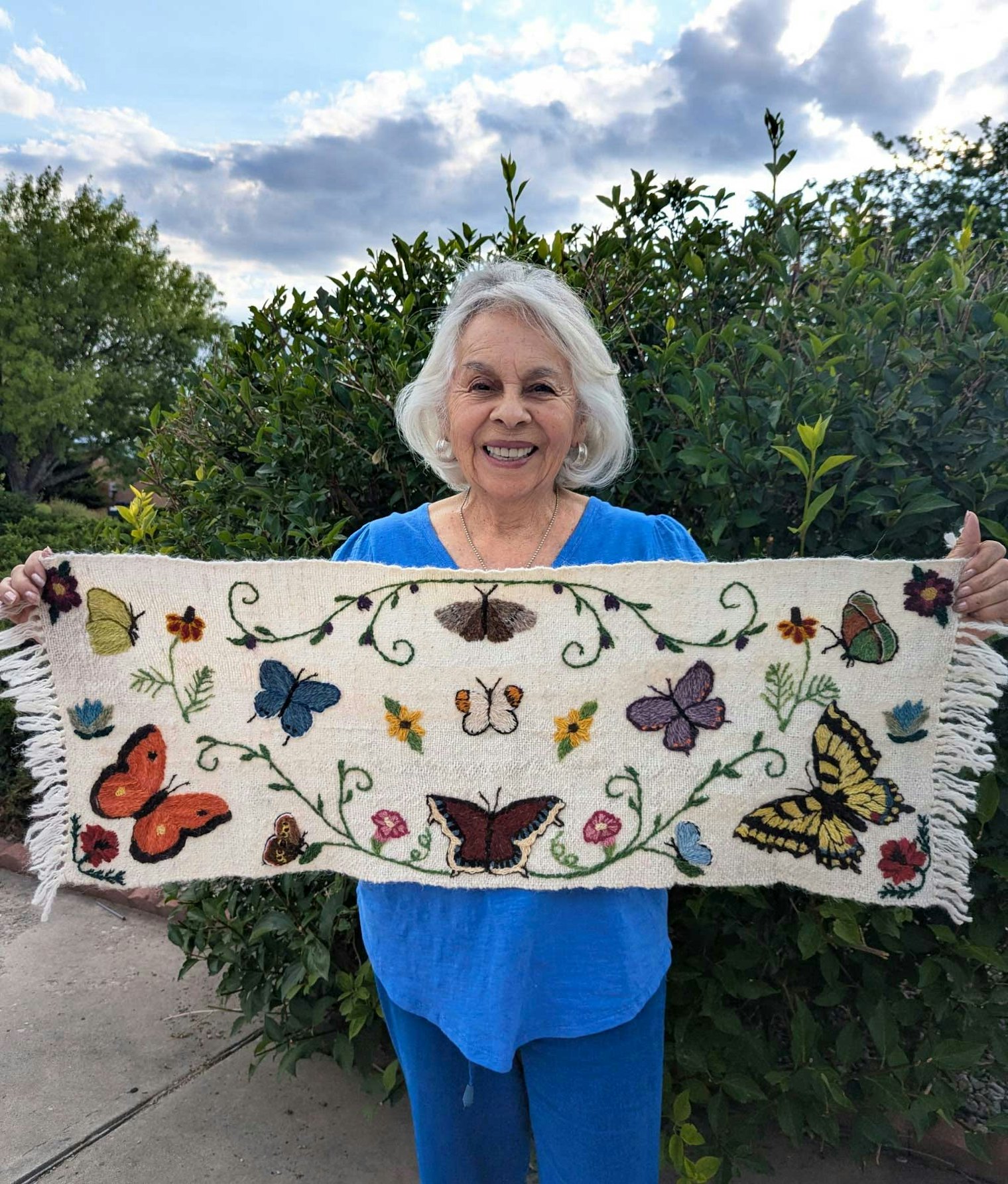 Julia Gomez holds her embroidered piece that was selected for a special exhibit at the Smithsonian in Washington, D.C. Photo courtesy of Julia Gomez