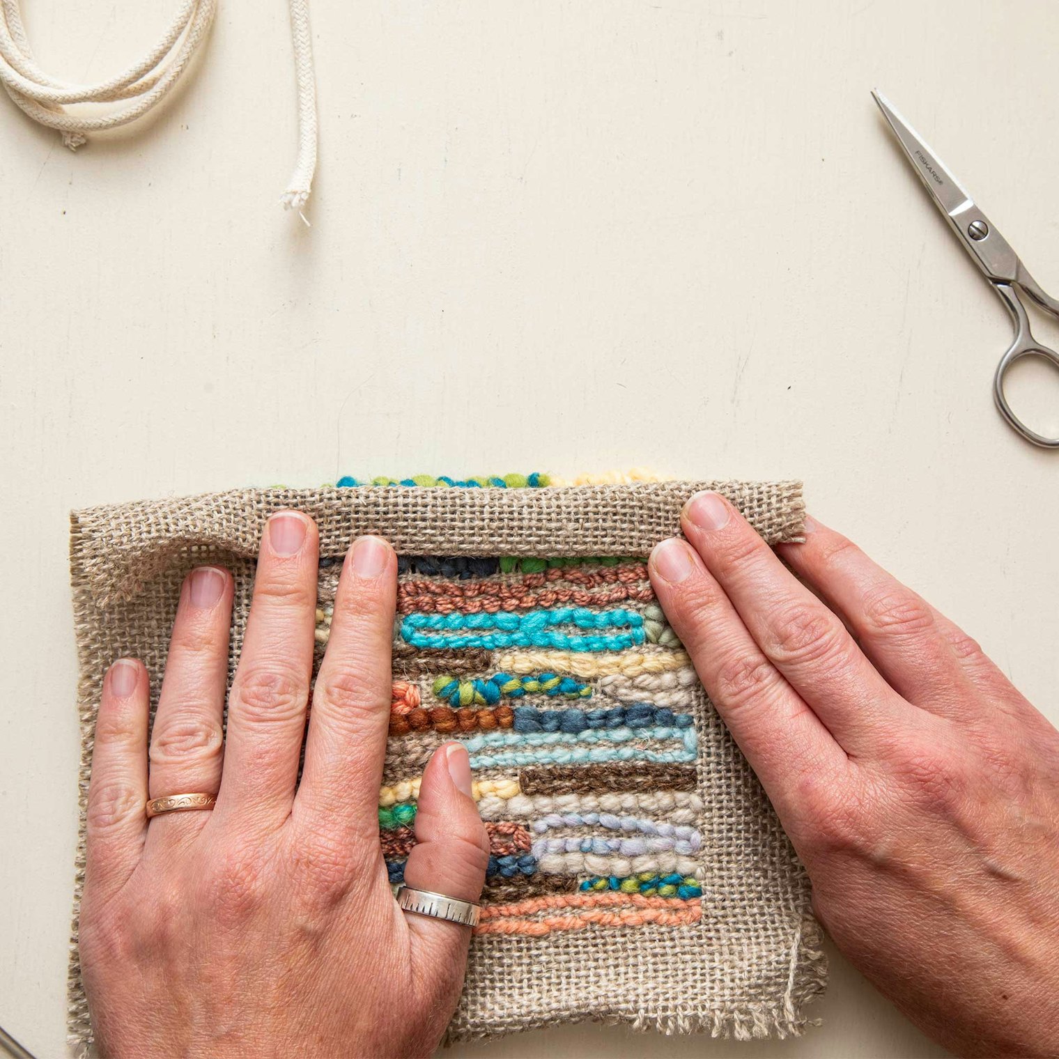 Fold the border towards the center of the work, then sew down.