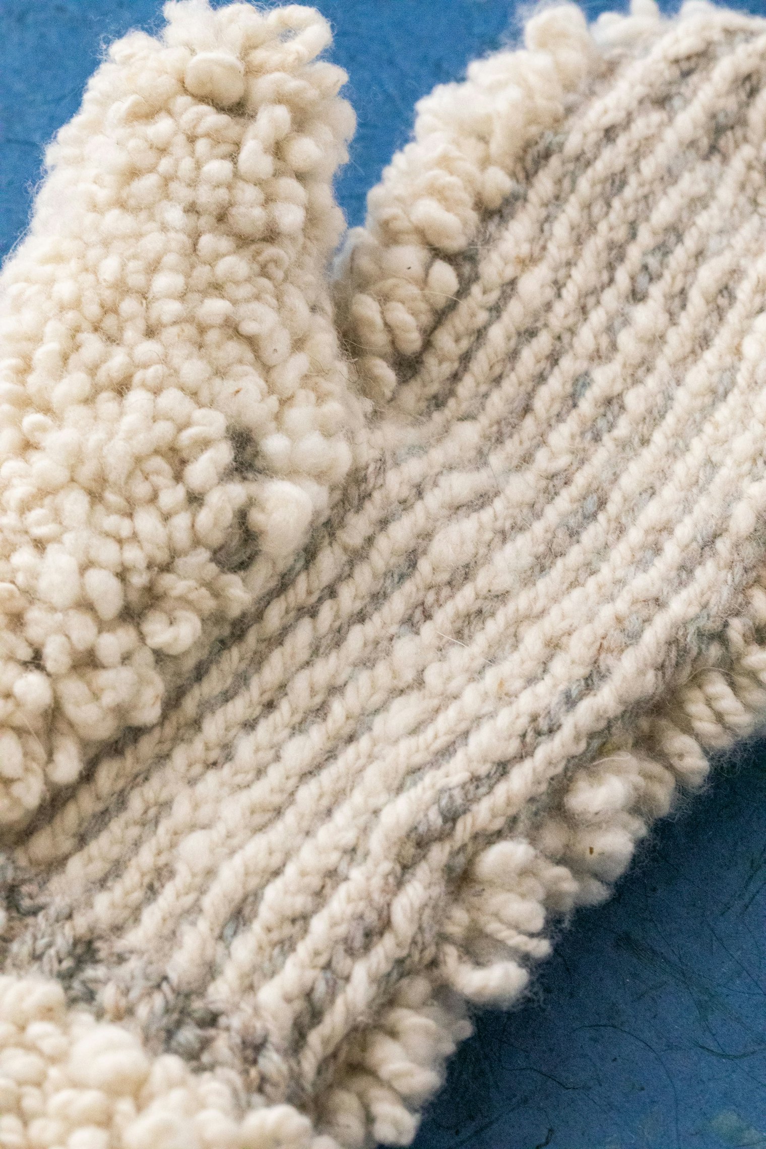 "The mittens are 50 percent Cashmere blended with Merino from Whitefield Farm in the Northeast Kingdom of Vermont for the white of the glacier and 50 percent cashmere and a merino/silk blend that looked like the color of the stream."