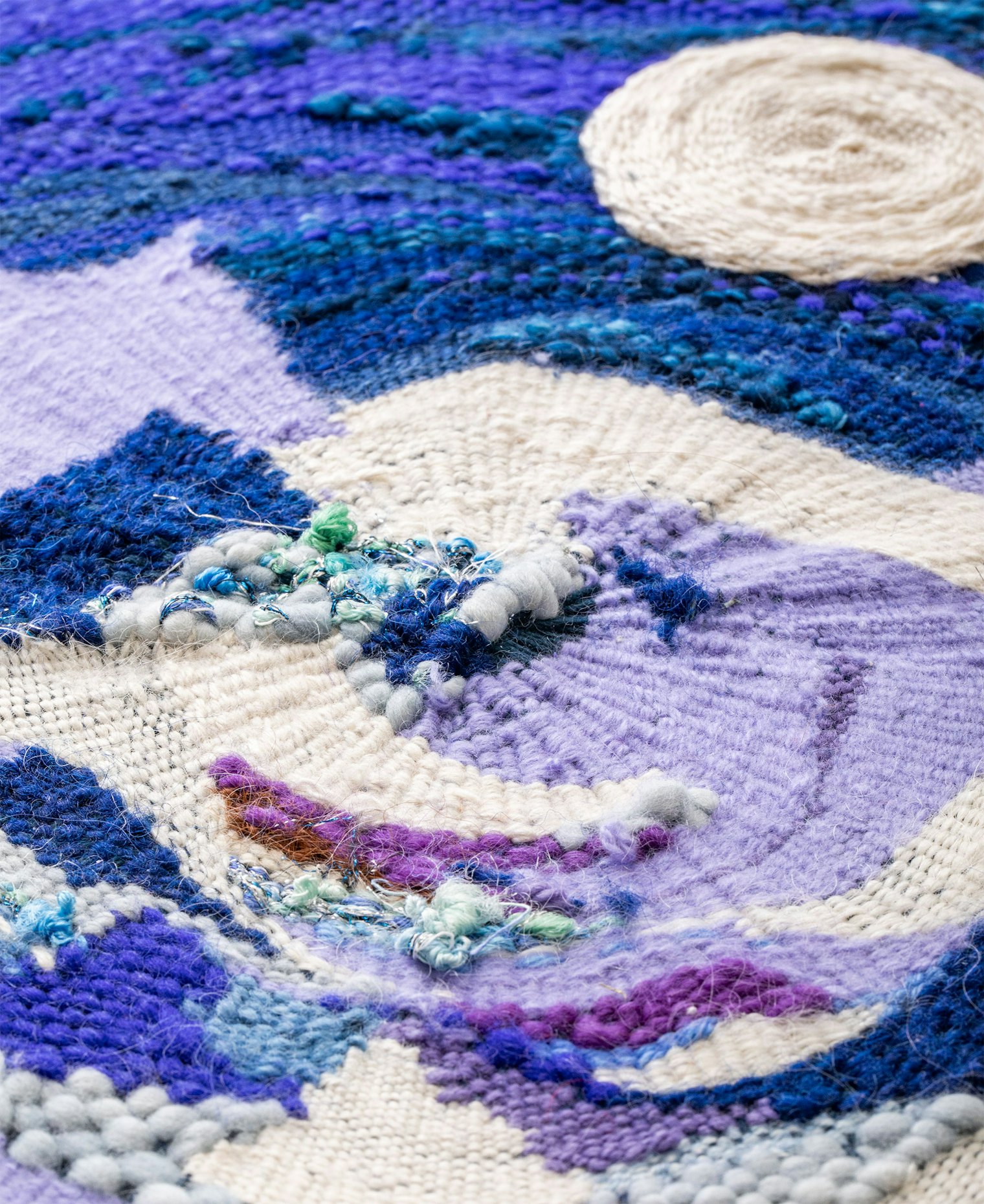 "The lavender shapes are 100 percent cashmere, White shapes are 45 percent cashmere, 55 percent silk, other areas include sheep wool, bison wool, linen, cotton warp and a minuscule touch of mixed fiber content."
