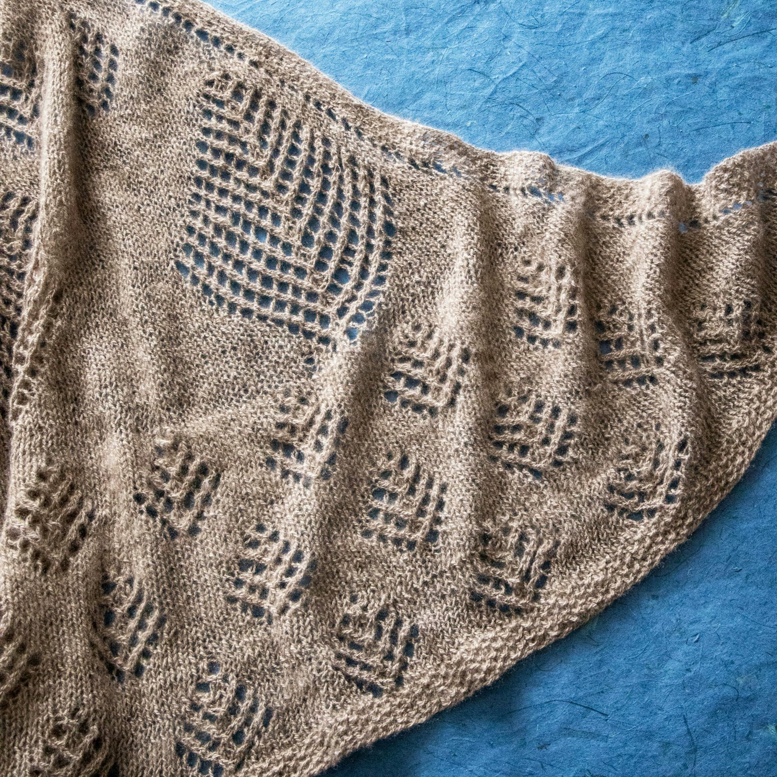 "The Shetland Tree of Life motif, which can be knit in many various sizes, represents the need for preserving the glaciers to save the environment. This shawl uses three different sizes of the Shetland Tree of Life motif."