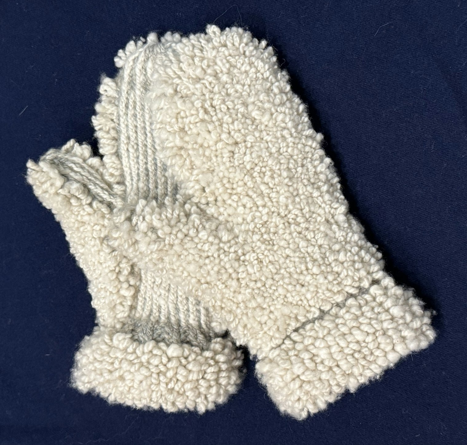 Glacier Inspired Buff Mittens. Photo and submission from Carol A. Pearsall. "This entry was inspired by a picture of a glacier and a stream."