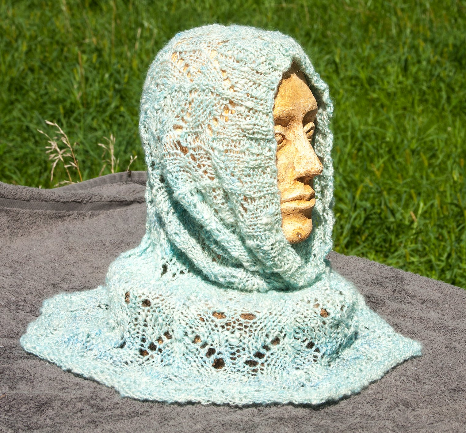 Glacial Ice Hood. Photo and submission from Jeanie Fraas. "When plyed together, the white cashmere and pale blues and greens in the wool reminded me of the glaciers. Then I designed and knitted a lacy hood."