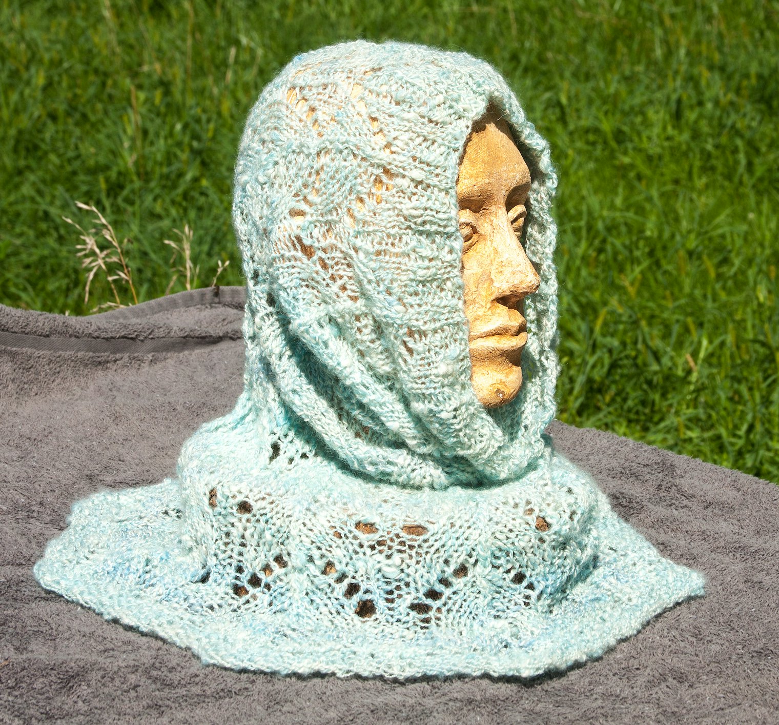 Glacial Ice Hood. Photo and submission from Jeanie Fraas. "When plyed together, the white cashmere and pale blues and greens in the wool reminded me of the glaciers. Then I designed and knitted a lacy hood."