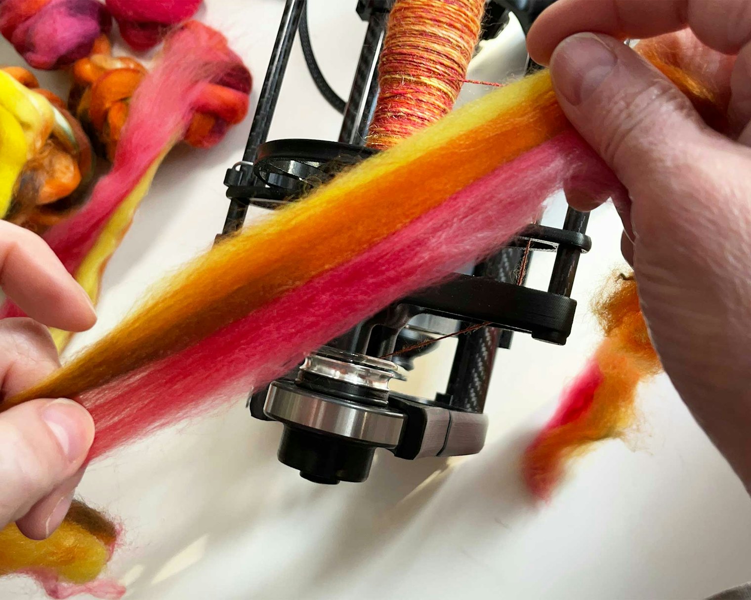 Pre-draft your narrow strips of fiber as a unit. The fibers will hold together better when you then apply a short draw, making unified spinning easier.