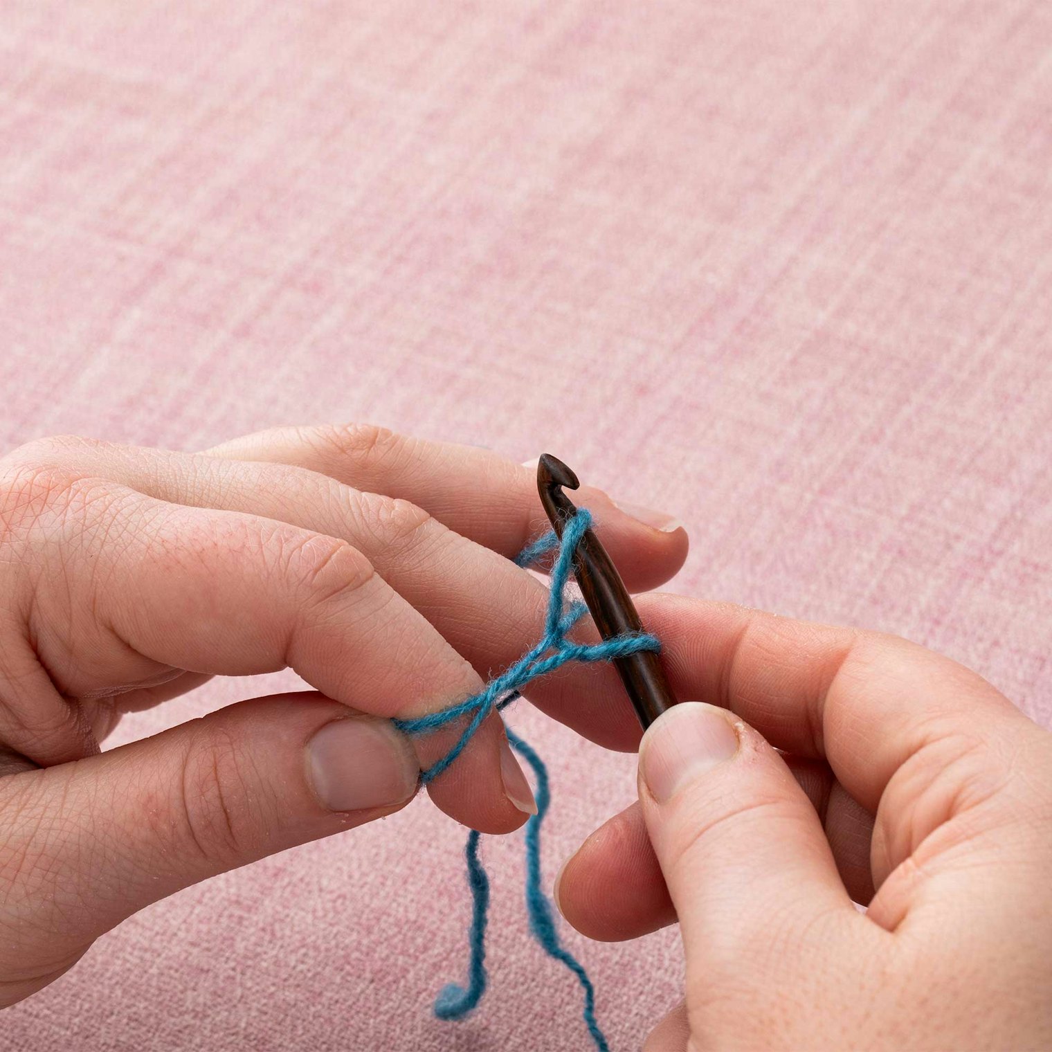 Make a yarnover with the long tail.