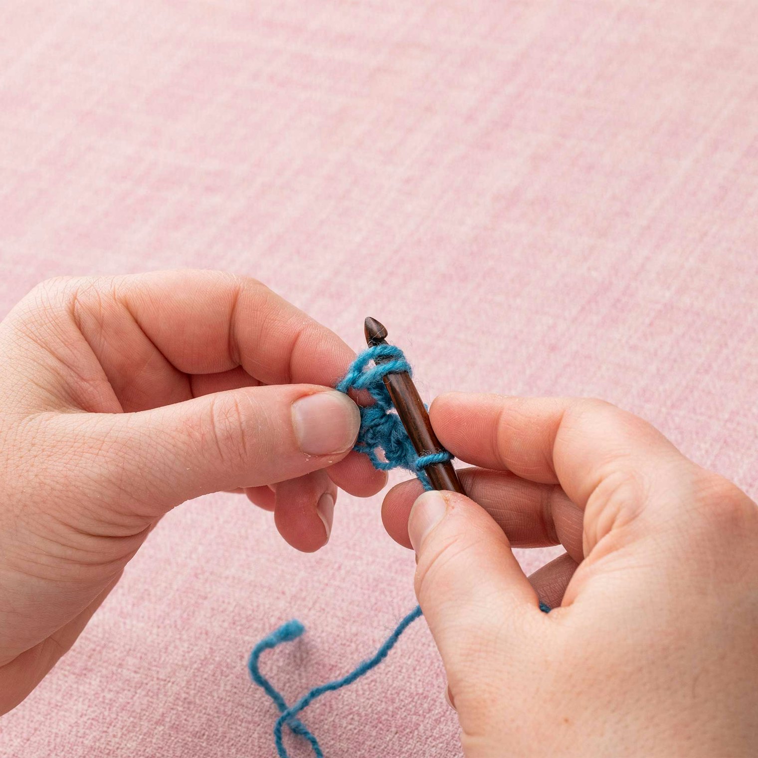 Pick up the two legs of the first stitch with your hook.