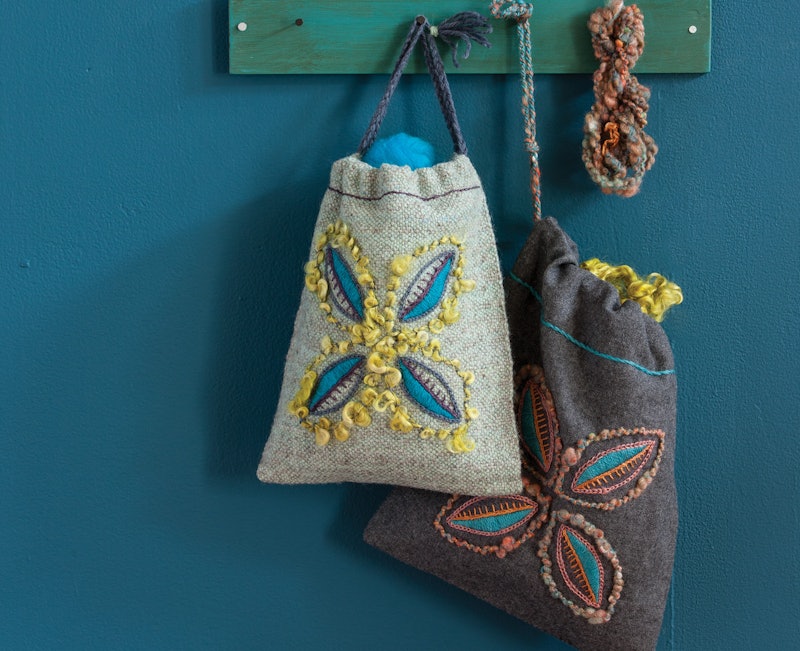 Two tote bags on a blue background.
