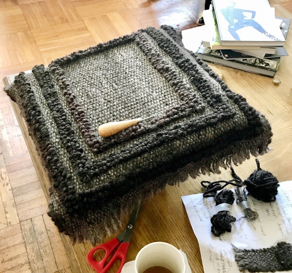 Rug hooking in progress. The finished mat measures 25 inches × 19 inches. Hook from Little House Rugs. Photo by Sahara Briscoe
