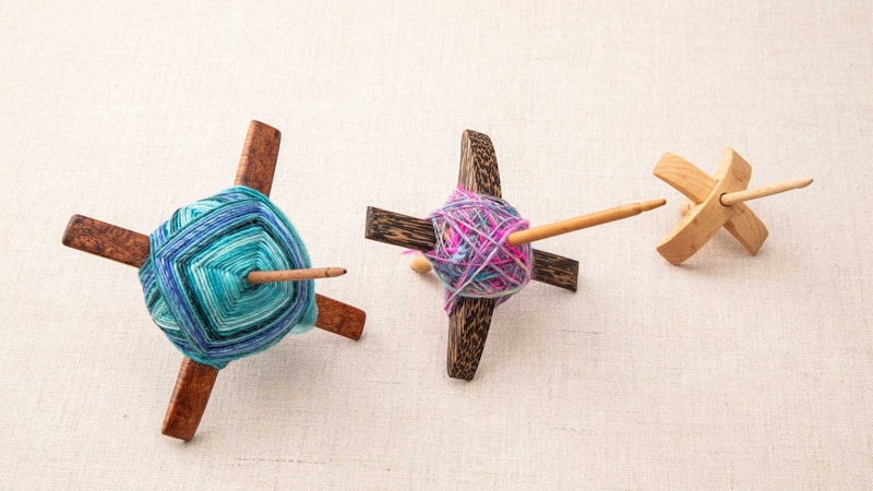 Three Turkish spindles on a beige background.