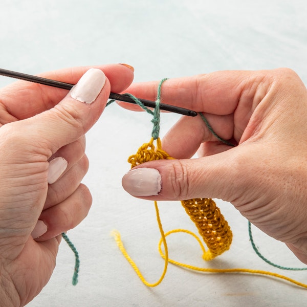 Step 5.Complete the double stitch as normal, yarn over and pulling through loops twice.