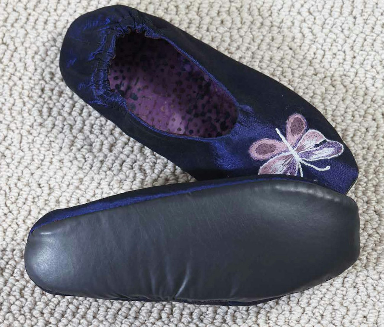 The Naugahyde sole on the slippers will keep your feet dry in most airplane situations. 
