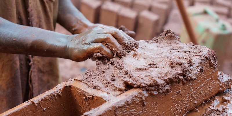 Person holding clay