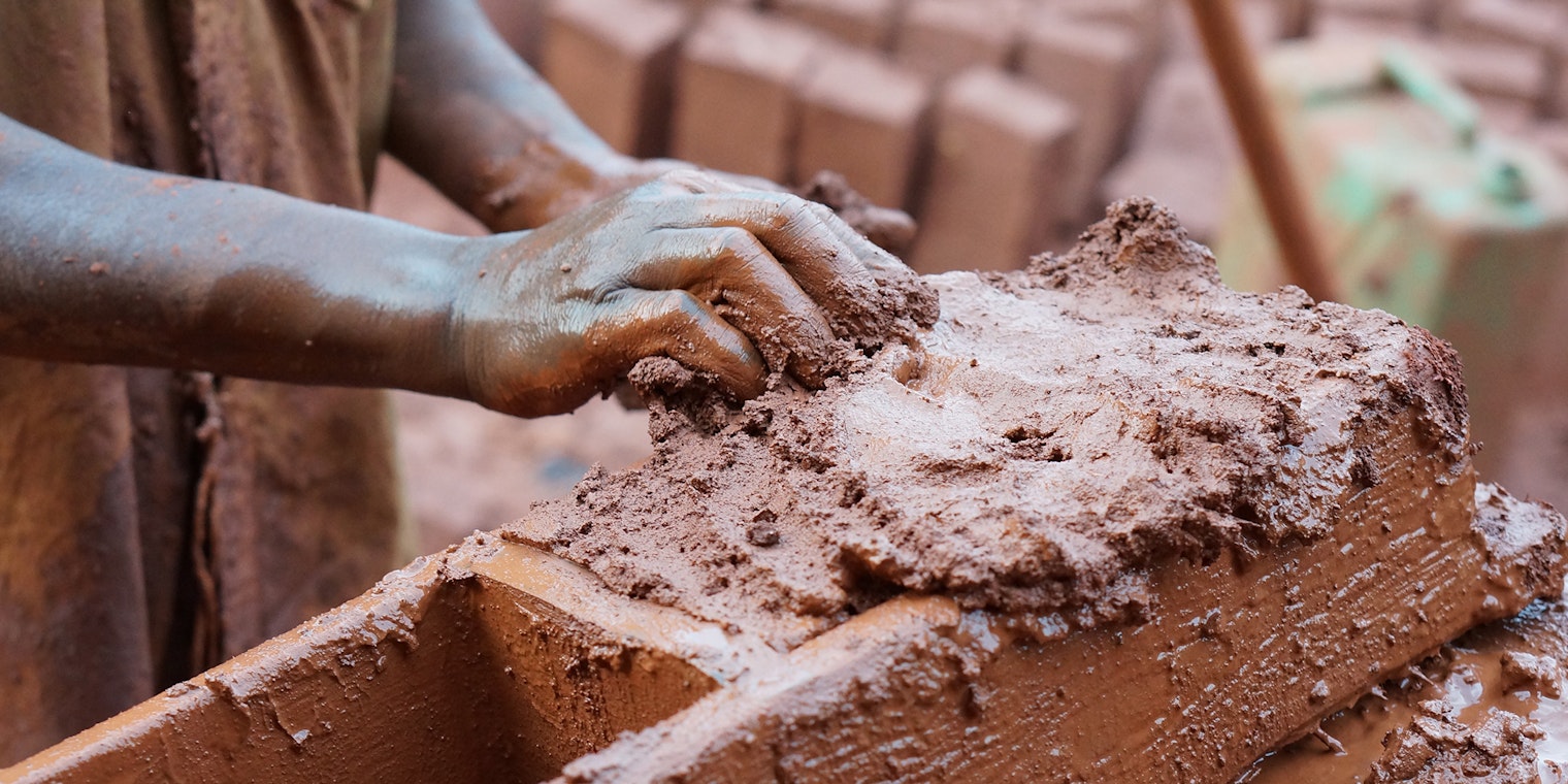 Person holding clay