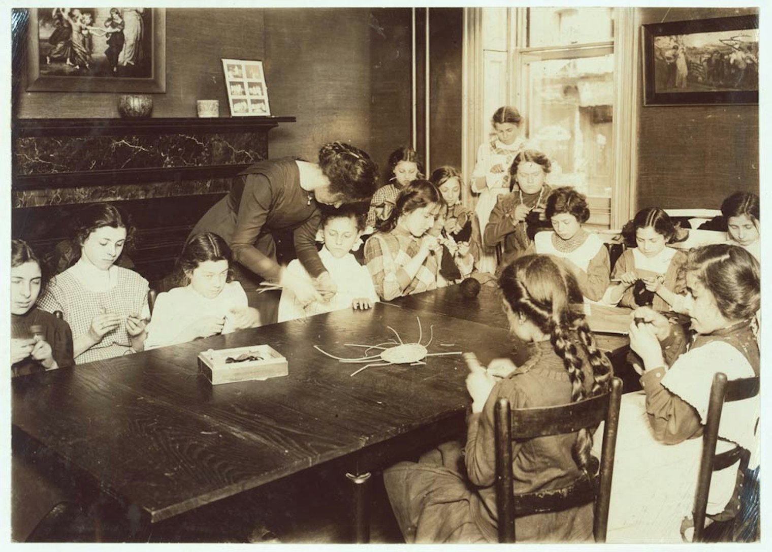 >Photograph of a knitting class at the Henry Street Settlement, New York, New York, by Lewis Wickes Hine (1874–1940). May 1910. National Child Labor Committee Collection, Library of Congress Prints and Photographs Division, Washington, D.C. (LOT 7483, v. 1, no. 1044.) Photograph courtesy of the Library of Congress Prints and Photographs Division