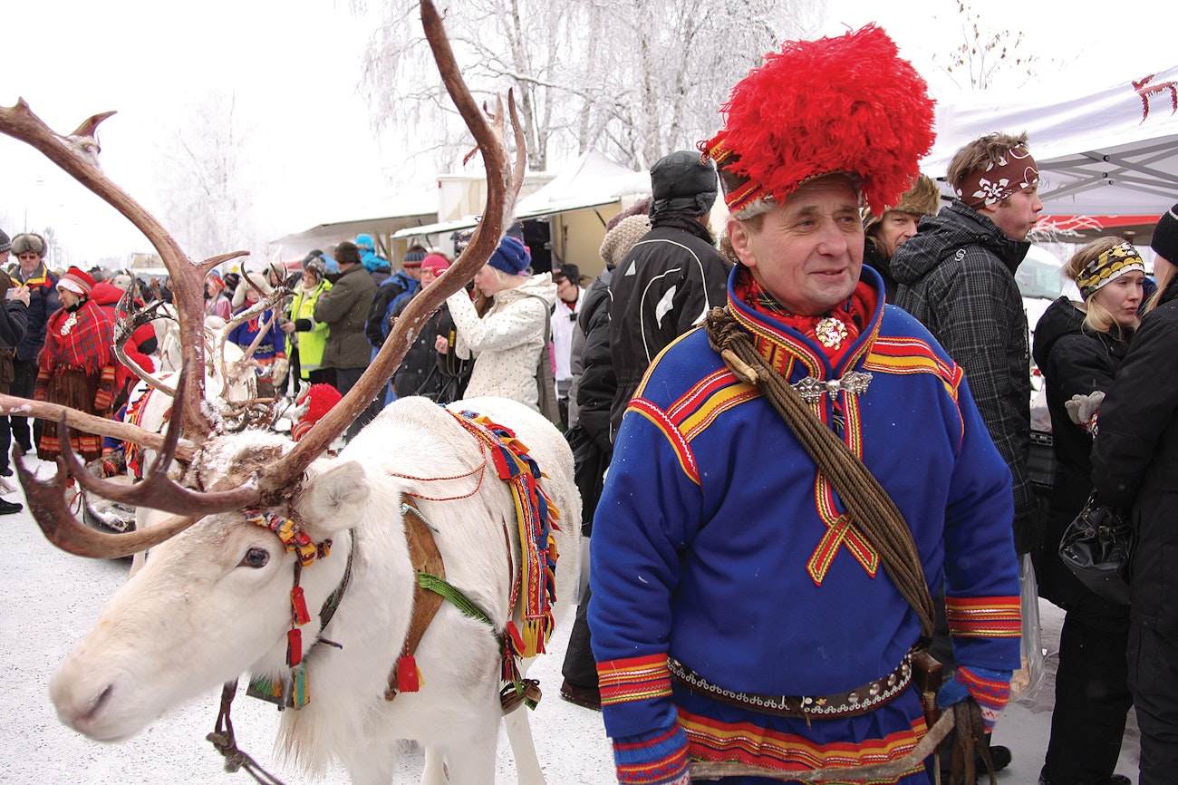 Per Kuhmunen leads the reindeer caravan down the main streets of Jokkmokk during the town’s Winter Market. Per’s čuipi (hat) has the large, red pom-pom (diehppi) on top. Jokkmokk, Sweden. 2011. Photograph by Petter Johansson and courtesy of Jokkmokk Winter-Market/ Jokkmokk Municipality.