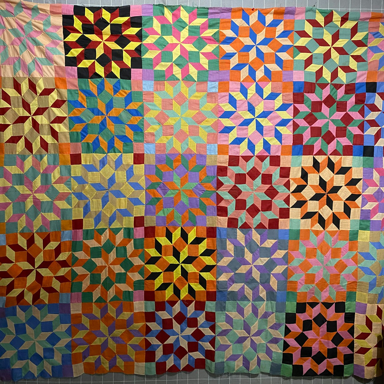 Brightly colored quilt of squares and diamonds