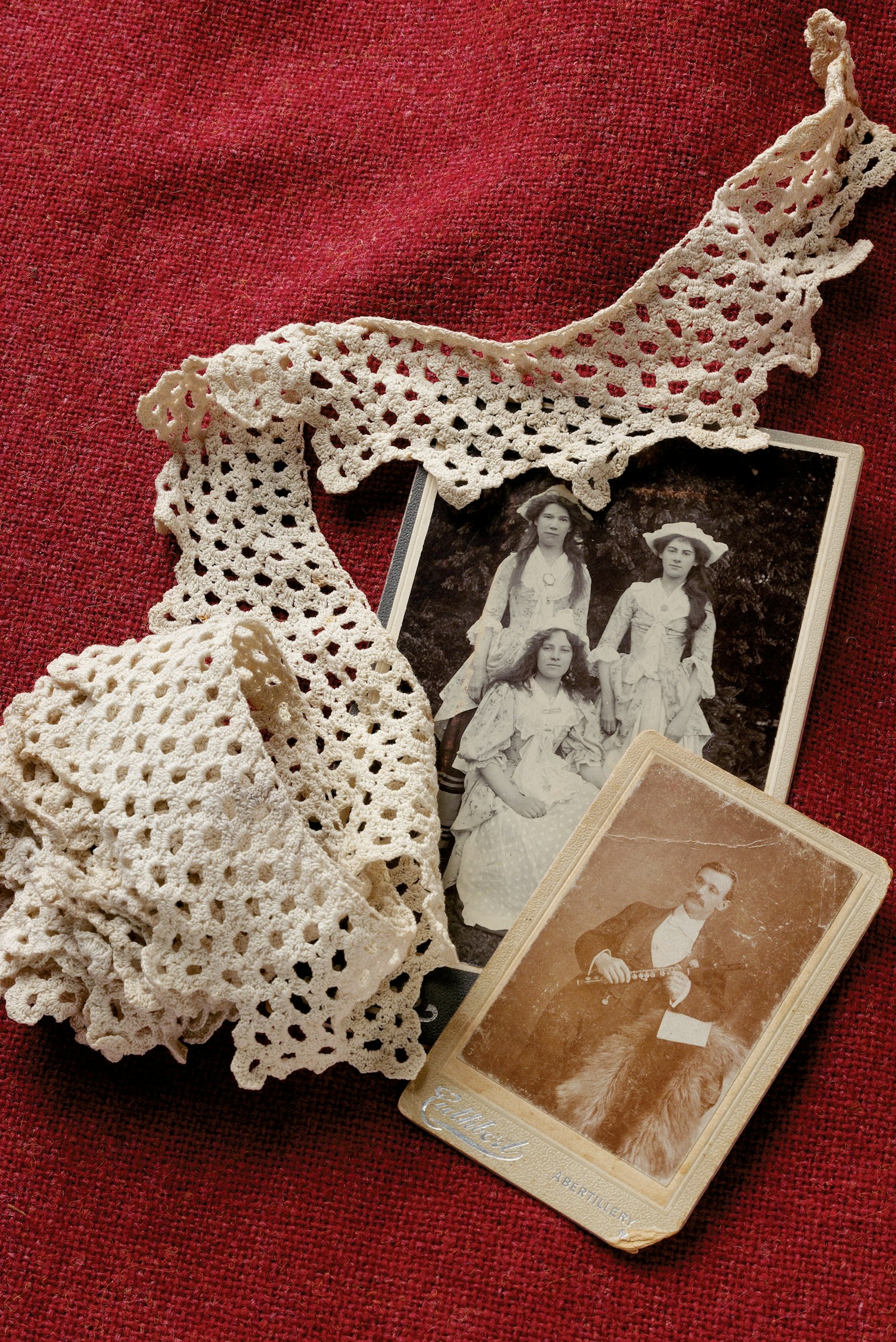 Crocheted lace and two black-and-white photos
