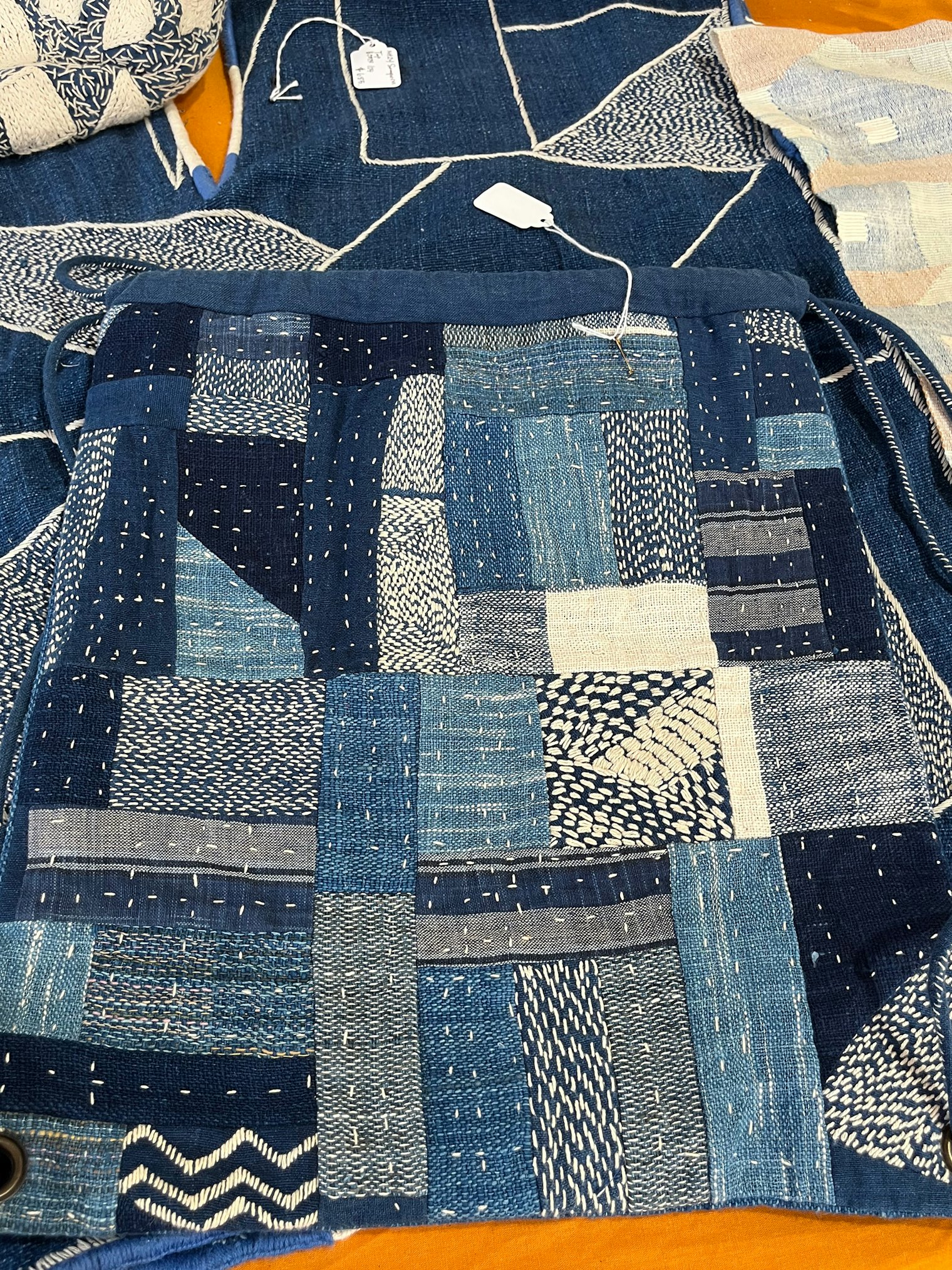 Somporn combines myriad fabrics and stitches to make a gorgeous backpack, using traditions past for contemporary use. Photo by Karen Brock