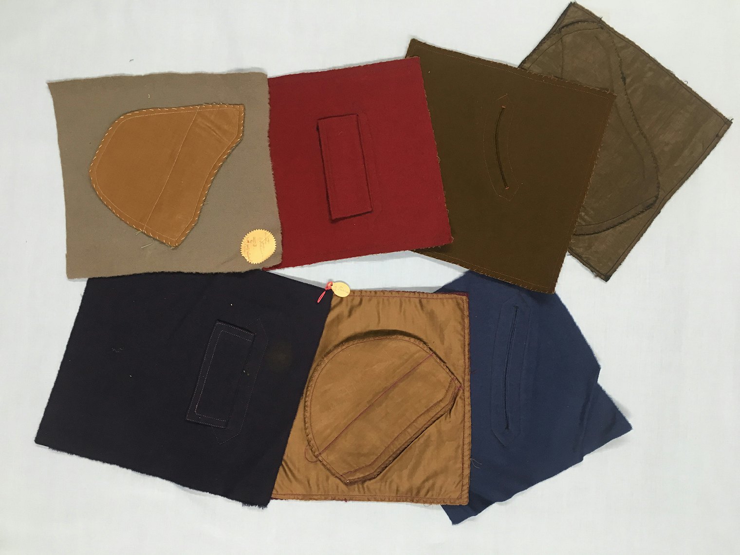 Pierce students’ samples. This collection of student work shows samples in wool of slash pockets with welts or flaps. All are sewn with a single thread, chain stitch on a sewing machine. One is labeled “Dorothy Hensen III. C. not well shaped.” Donor: Lucy H. Pierce. Historic Textile and Costume Collection, University of Rhode Island, URI 2019.98.06a–g.