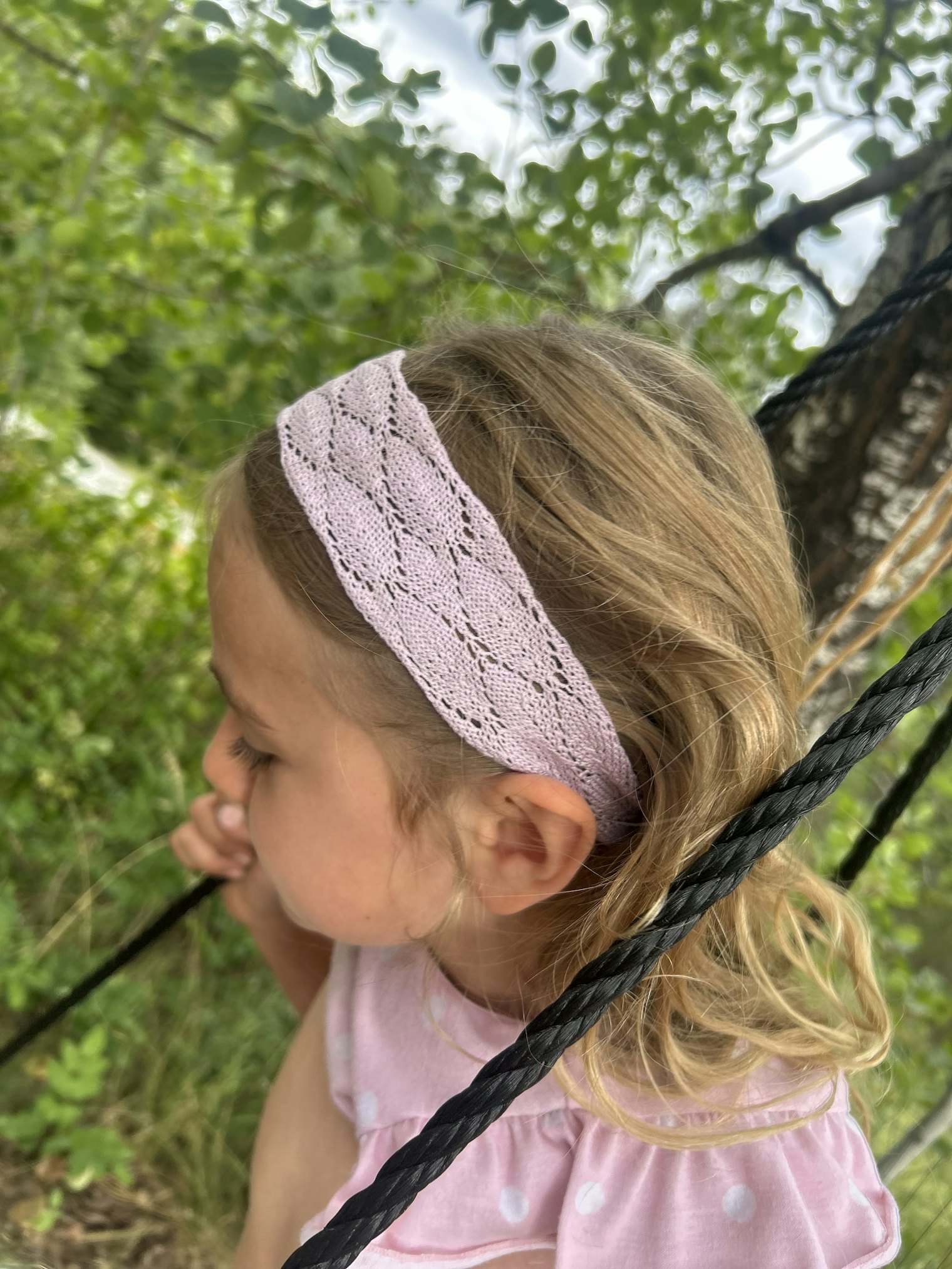 The headband keeps Ellowyn’s hair in place while she swings.
