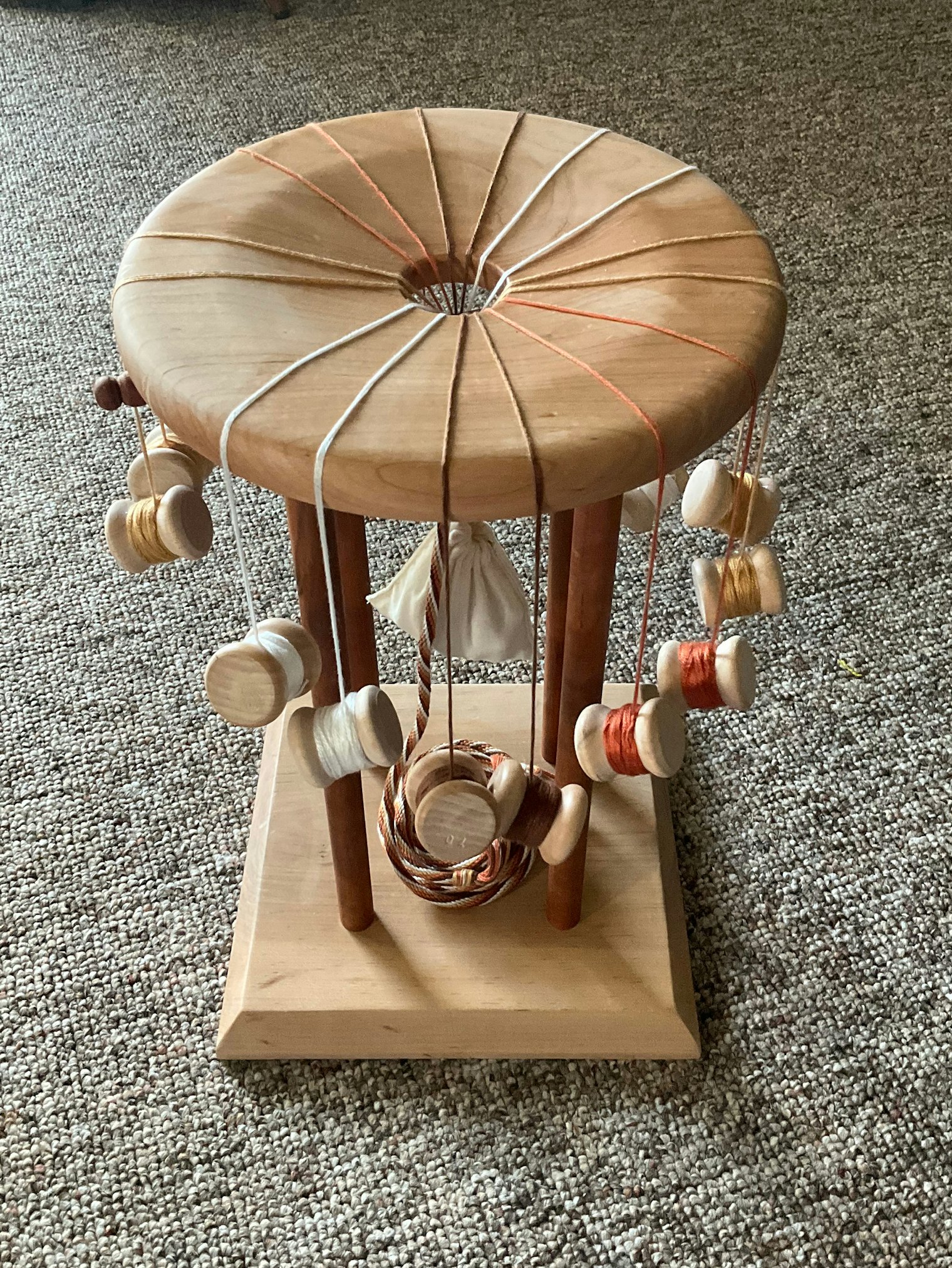 Traditionally, kumihimo is worked on a marudai stand.