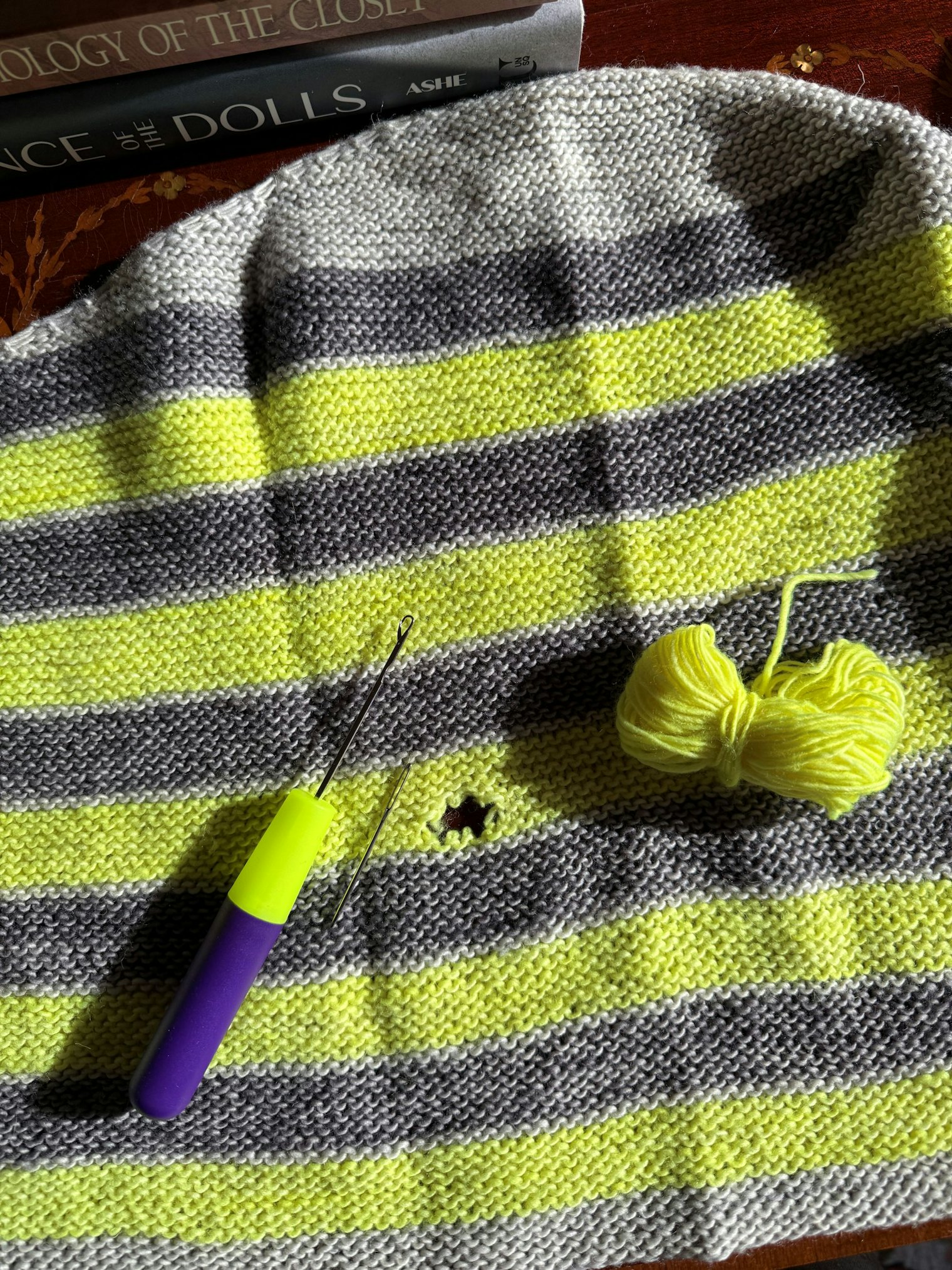 One of Nicole’s handknit sweaters with a hole.