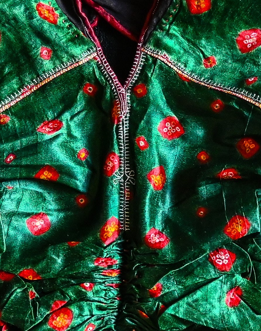 Kapadu detail showing the devadi, or shrine, patterns at the neckline and in the center panel, the mugro motif.