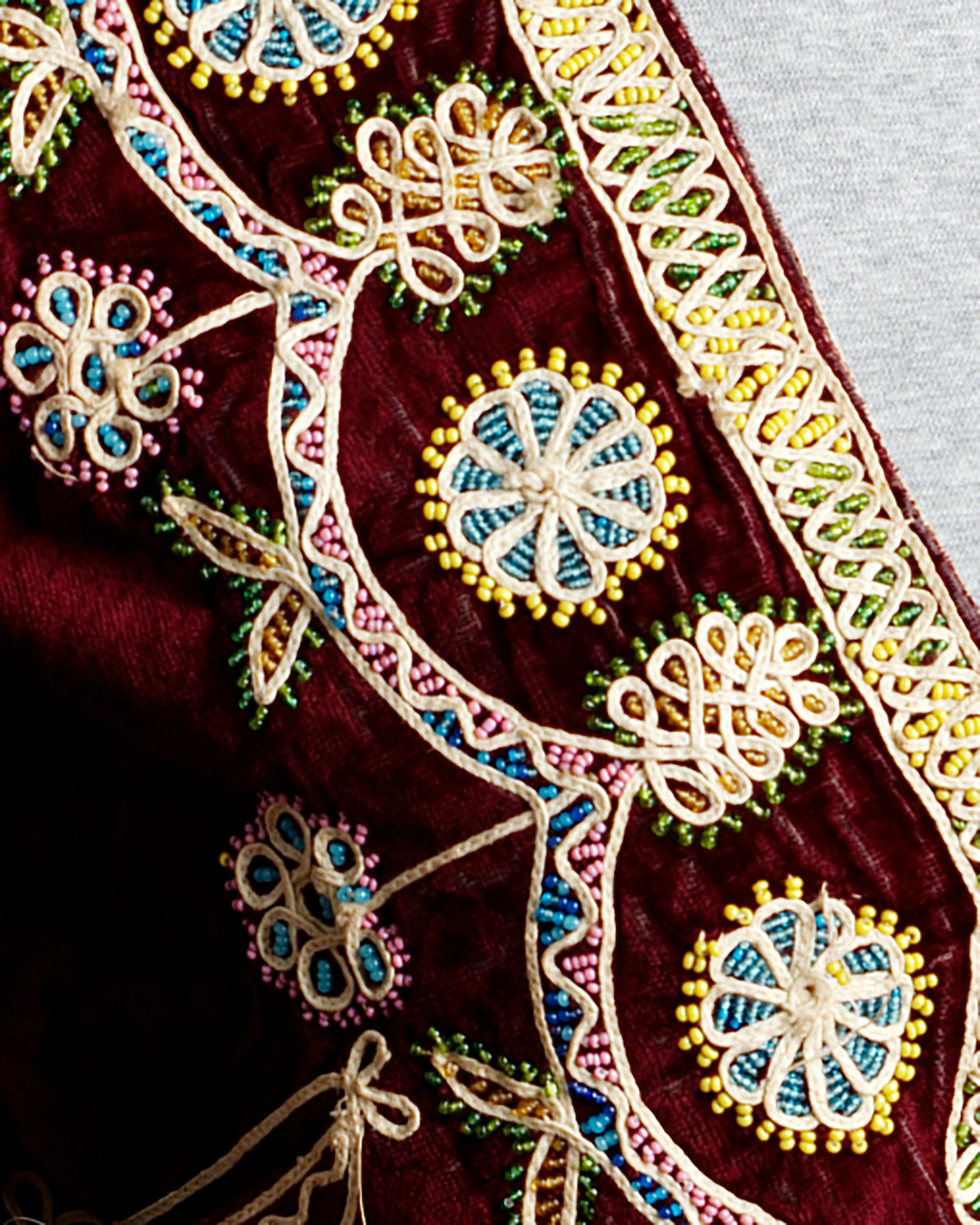  Historic garments such as this one typically are made of jewel-tone velvet, lined in cotton muslin, and elaborately decorated with intricate beading and narrow handworked braid. Today, the chaquetilla is worn with many layers of full skirts in bright colors; Chola women top off the outfit with a bowler hat.