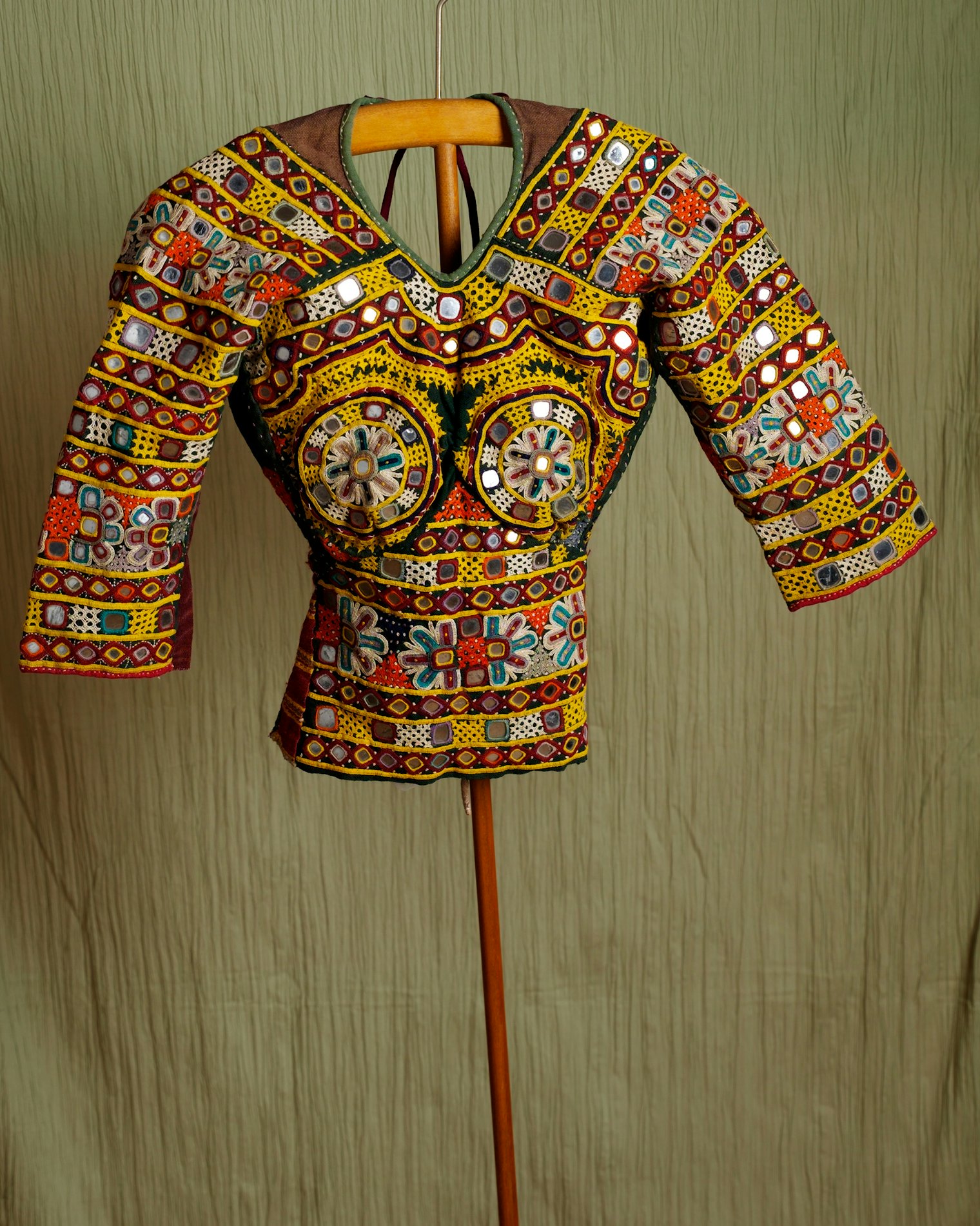Woman’s backless bodice, choli. Makers unknown. Kutch, Gujarat, India. Date unknown; purchased in the 1970s. Collection of Folkwear. Imagine how this backless bodice must have excited young women of the 1970s who were looking for alternatives to mainstream America’s beige A-line shifts and white blouses with Peter Pan collars. The tight-fitting, backless garment was cool in the desert region of Kutch; there, however, it always was worn with a lightweight veil covering the back for modesty.