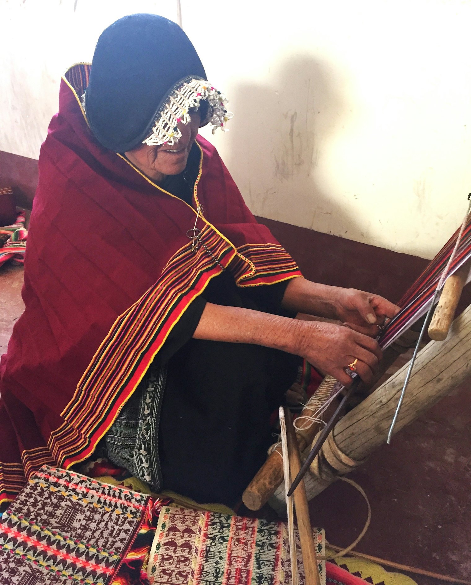 A Tarabuco weaver in Bolivia wearing a hat fashioned after the Spanish conquistadores. Photo by Linda Ligon