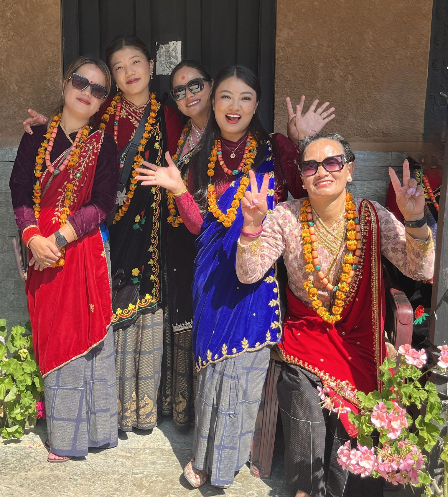Gurung women gather to celebrate at a wedding, each wearing a variation of festival dress, complete with chaubandi cholo, ghalek, and chitko gunyo.