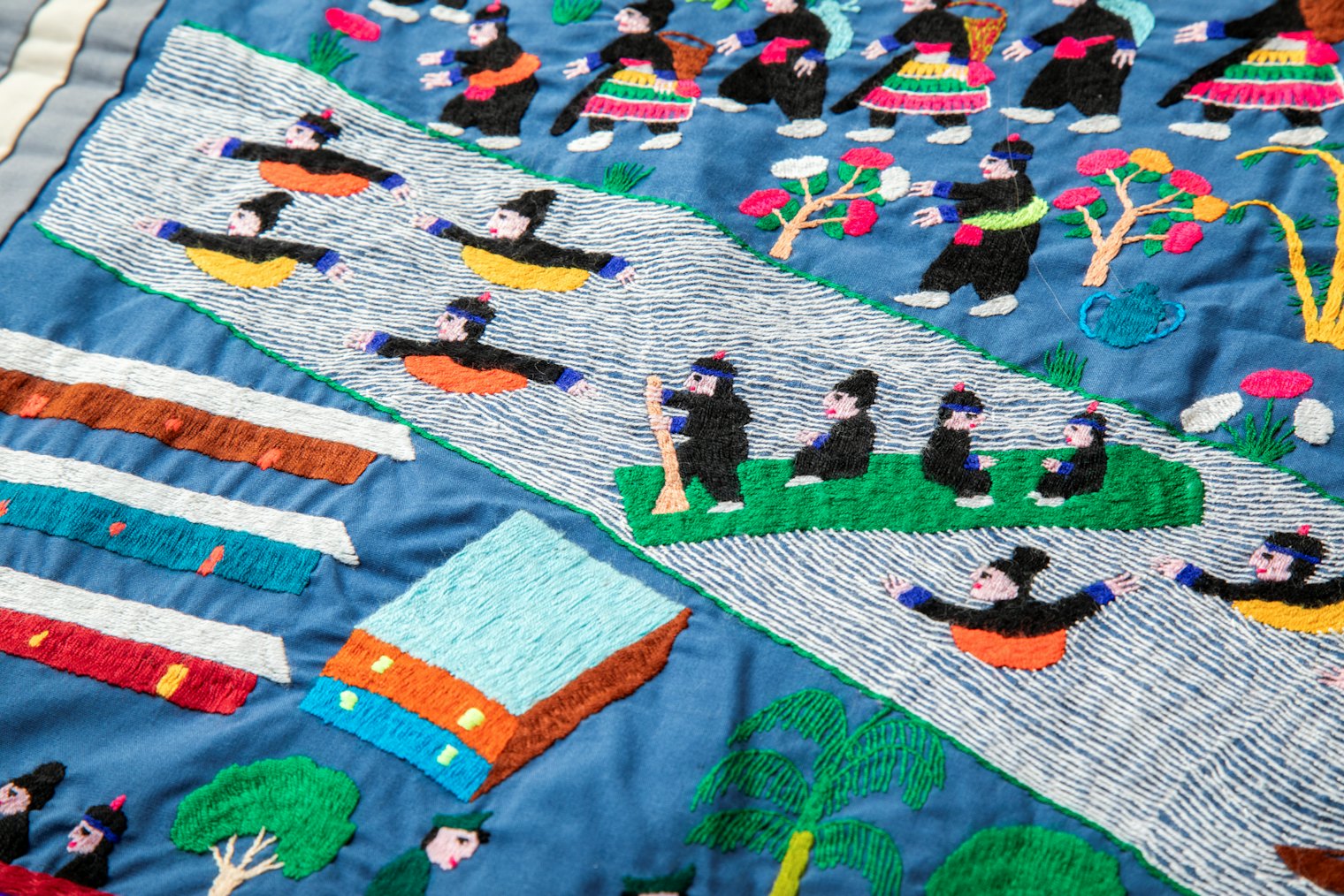 This scene from Joyce's story cloth illustrates the Hmong being driven from their homes and escaping across the Mekong River.*