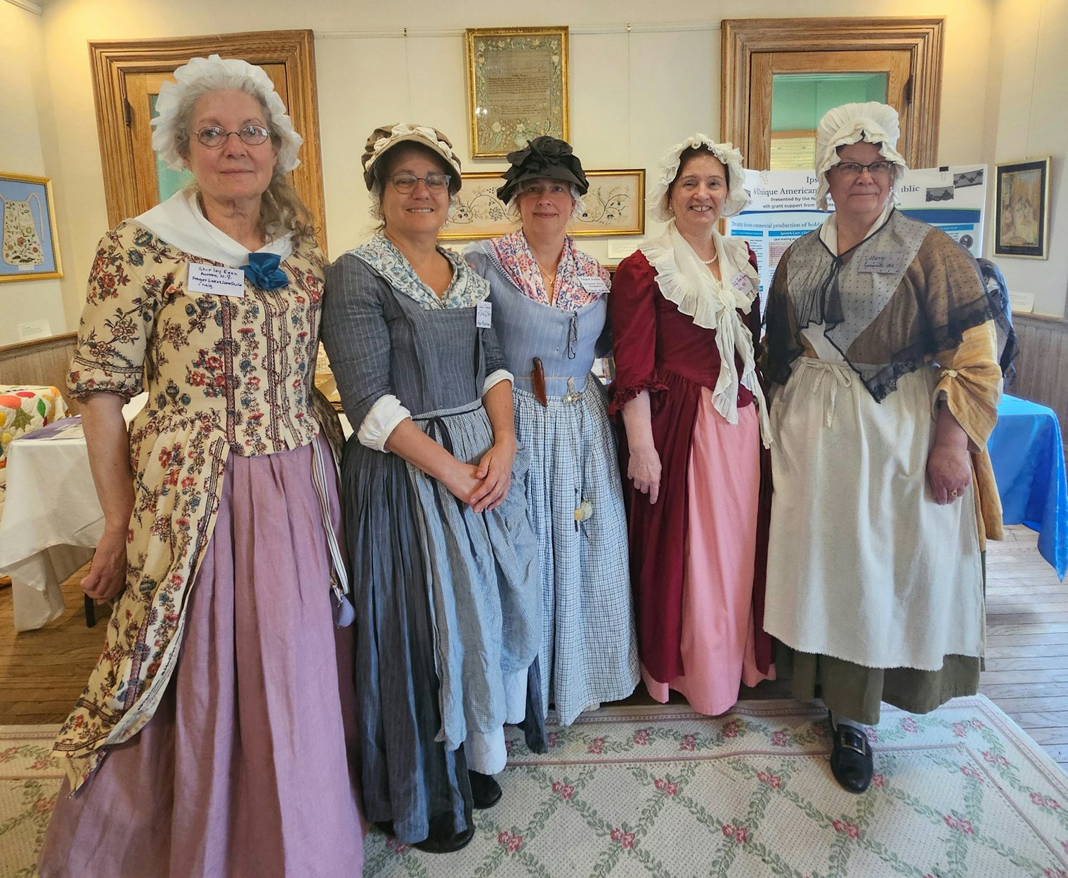 A group of lacemakers in period costumes who make and wear lace at historical demonstration sites to celebrate and educate about the history of lacemaking in the Revolutionary War era. Ipswich lace is a wonderful revelation to many visitors. Left to right: Shirley Egan, Susan Thomson, Becky Audette, Judith Jeon-Chapman, Mary Mangan.