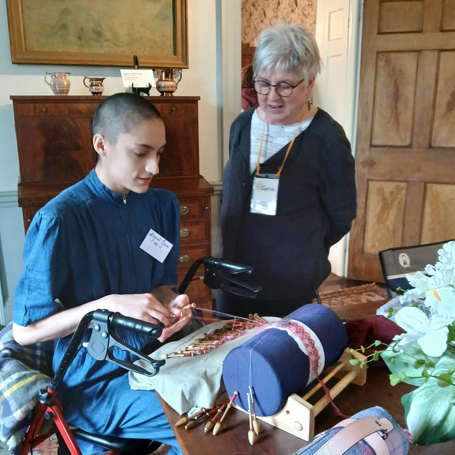 August Honey and Jodi Colella, an organizer of the Gather fiber symposium, discuss lacemaking at Ipswich Museum’s Heard House.