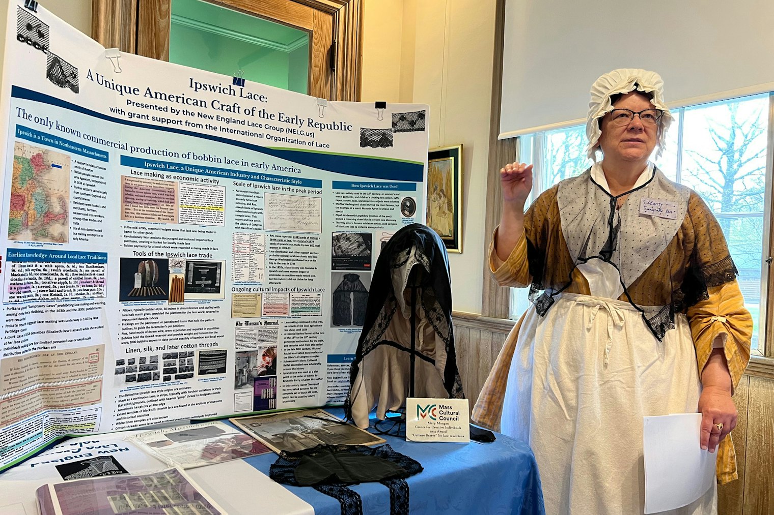 Mary E. Mangan discusses the research that she and the New England Lace Group have done to learn more about the industry and the historical practitioners of Ipswich lace. She also wears a black Ipswich lace trimmed shawl and shows other items on period reproduction garments.