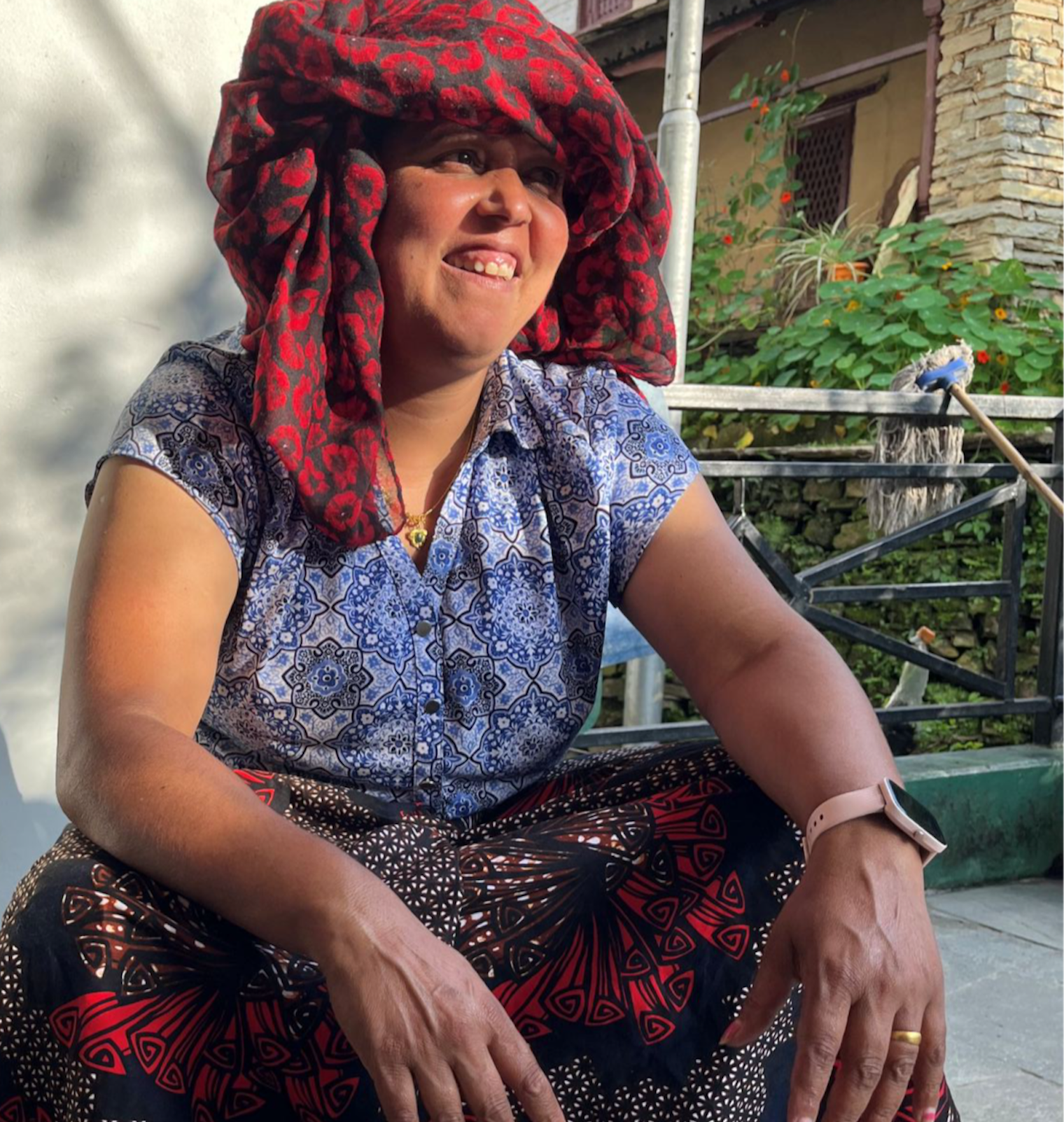 Tara, a hotel owner in Ghandruk, shields herself from the strong mountain sun with a pachauri draped over her head.