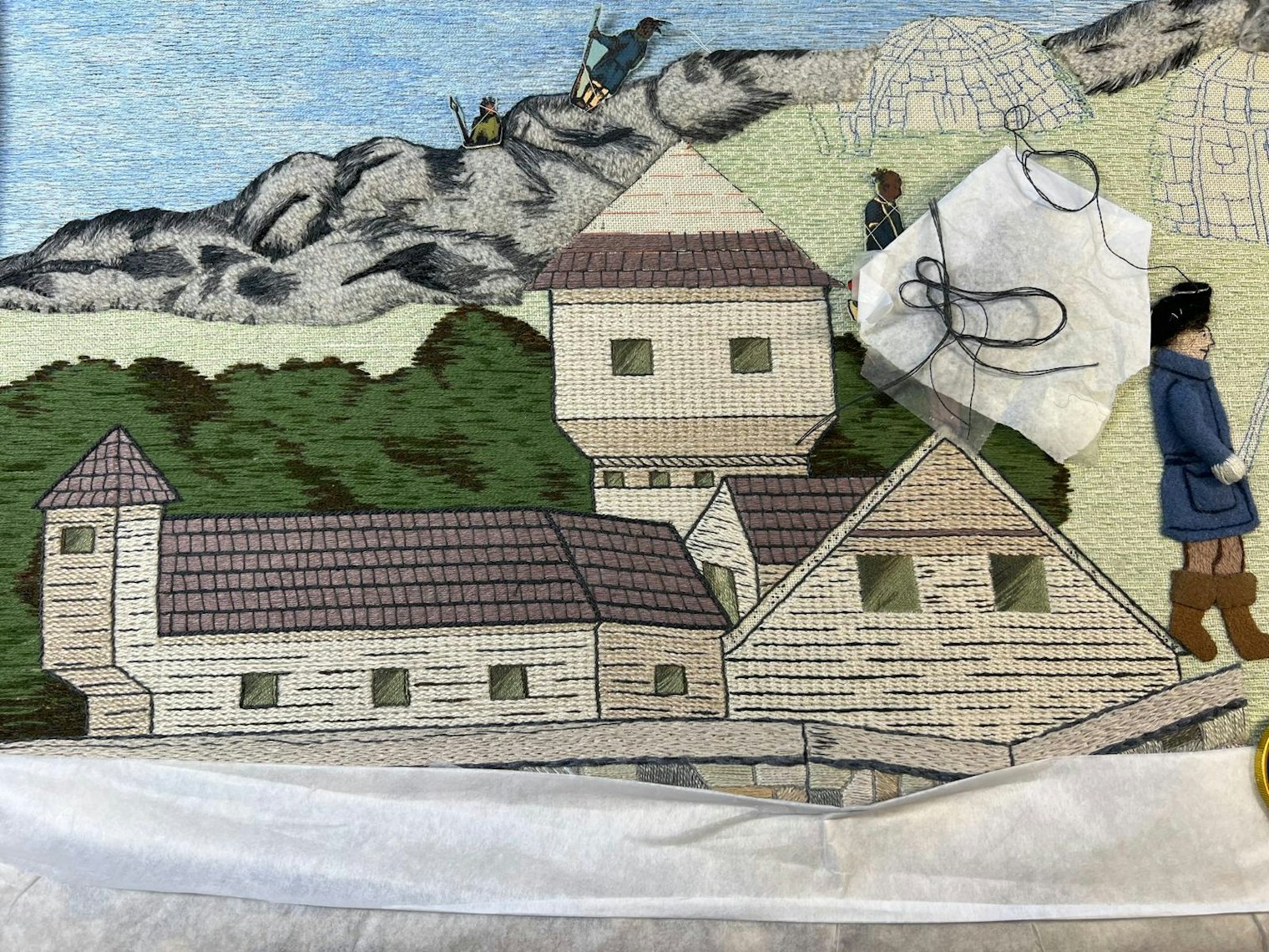 This motif depicts Fort William and Mary in Portsmouth,New Hampshire, and the raid led by patriots in December 1774, when they seized gunpowder barrels and supplies belonging to the British that were later used in the Battle of Bunker Hill.The fort was stitched by Carol Tewes Ganse, Vicki Blanchard, Pam Weeks, and Laura Morrison in a nested stem stitch filling using DMC and Valdani #5 pearl cottons. Pat Kelly and Kim Whitworth used backstitches in DMC stranded cotton to emphasize the log structure of the buildings at that time. The buildings’ roofs were stitched by both Carol and Heidi Levesque in laid stitch using linen threads which were then couched down with buttonhole stitches in DMC stranded cotton. The roofs’ outlines were couched with DMC #3 pearl cotton. New Hampshire State Coordinators are Carol Tewes Ganse and Michelle McPheron.