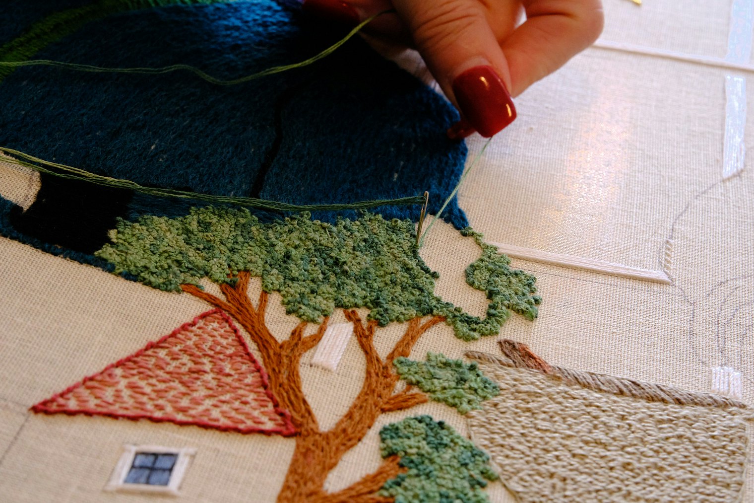 Detail of the Massachusetts panel. The many French knots that comprise the tree featured here have been completed by volunteer Anne Hart Davies.