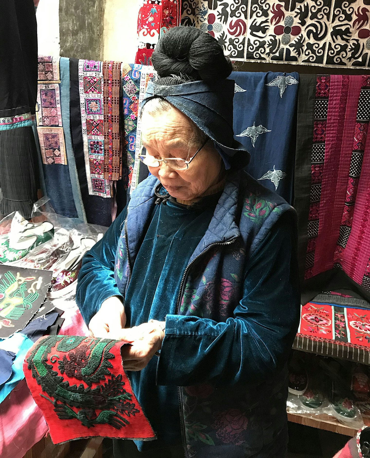Wen Kui Xiang works at her couched braid embroidery at her home in Langde, Guizhou, China.