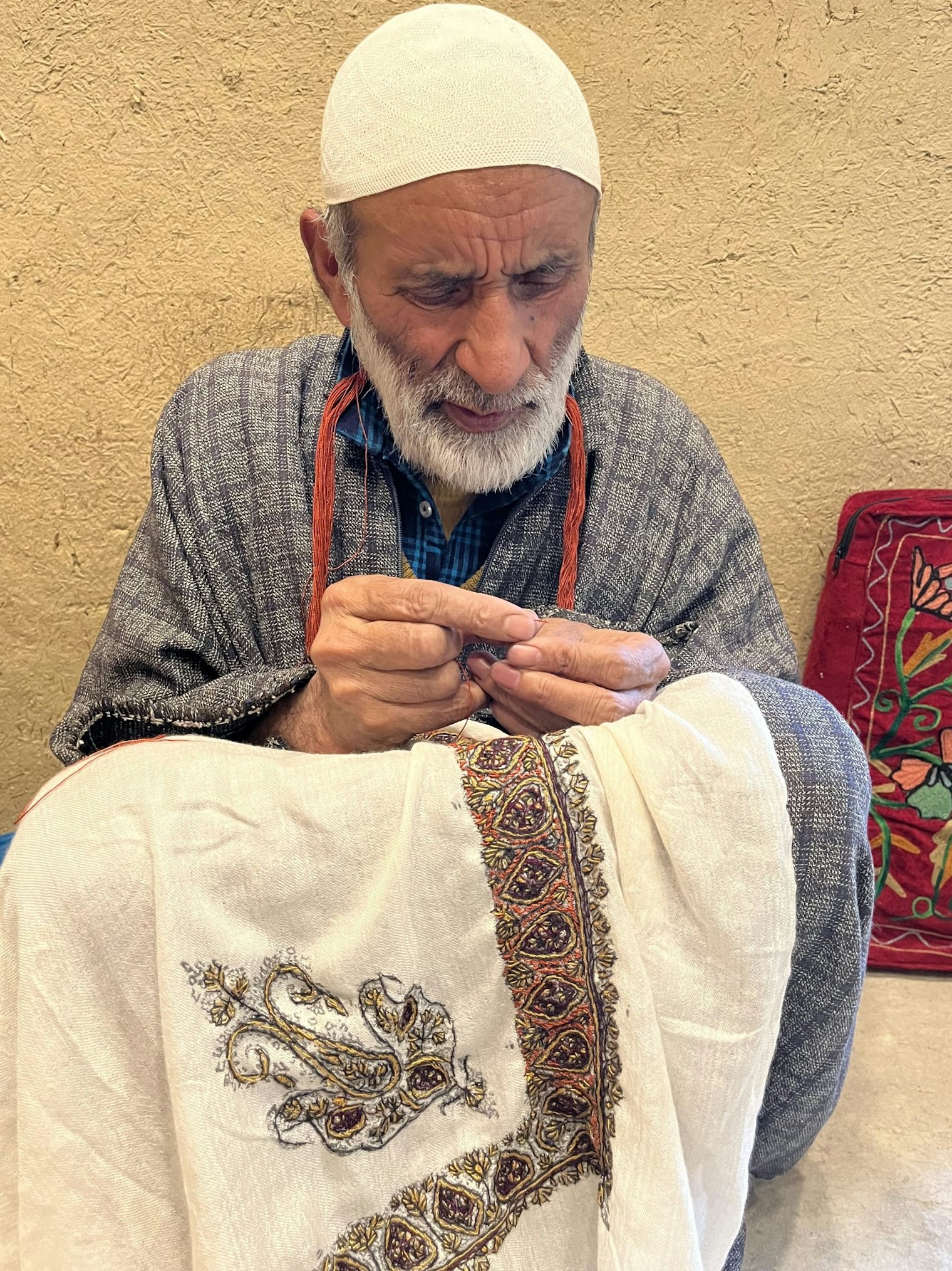 A embroiderer stitches ancient designs on a pashmina on the outskirts of Srinigar, India.