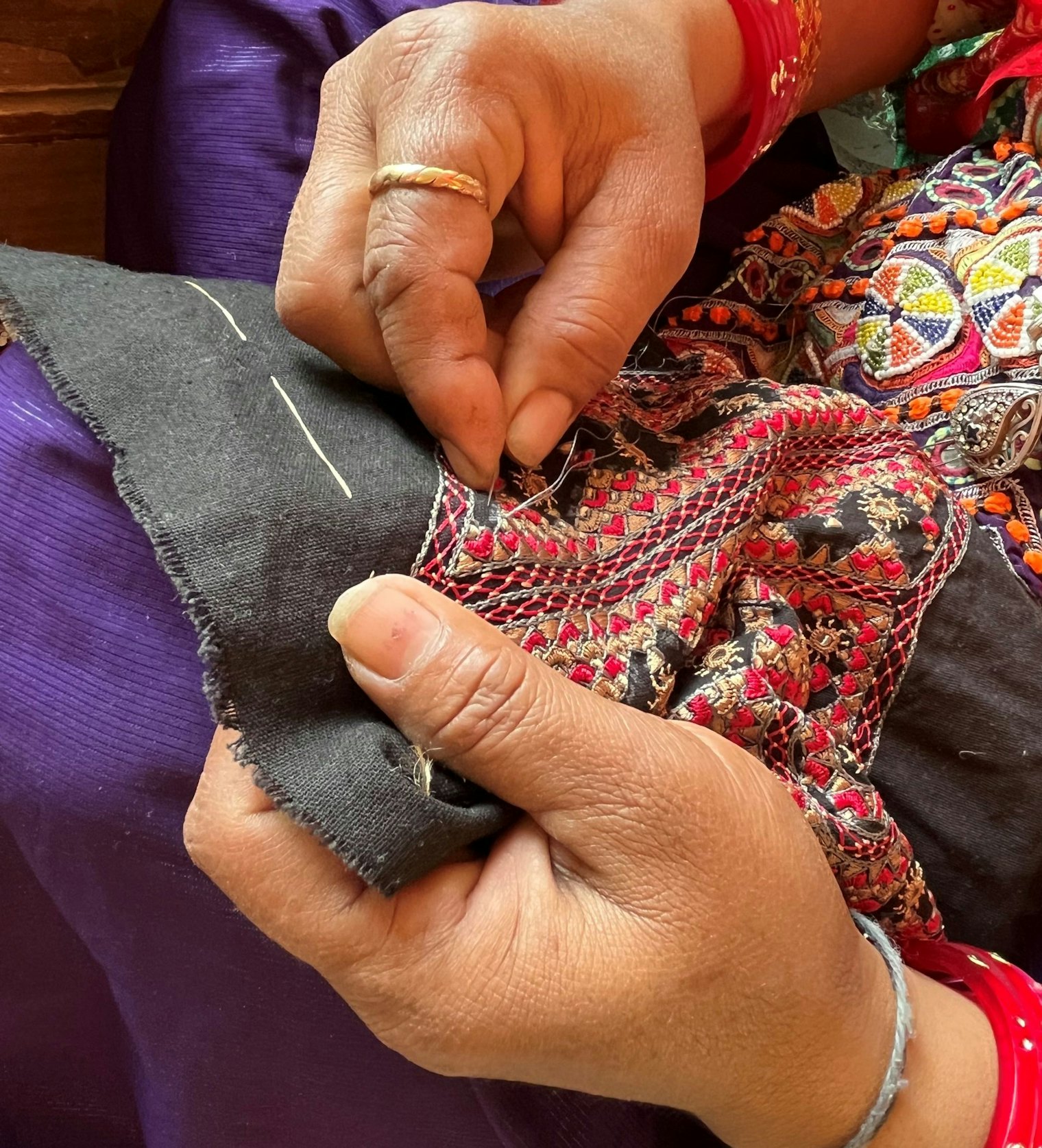 An embroidery artist stitches at a cooperative in Bhuj, Gujarat, India.